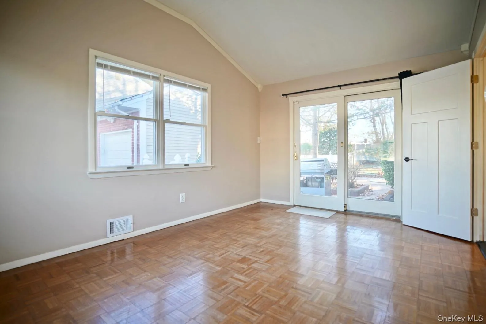Spare room with lofted ceiling and baseboards Spare room with lofted ceiling and baseboards