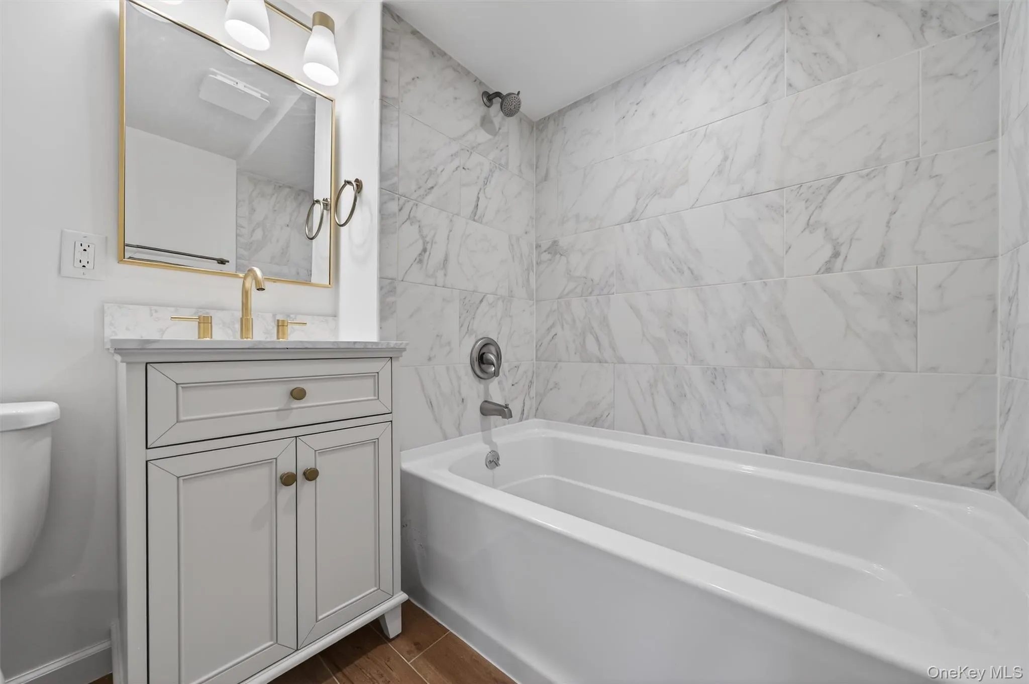 Full bathroom featuring vanity and tub / shower combination Full bathroom featuring vanity and tub / shower combination