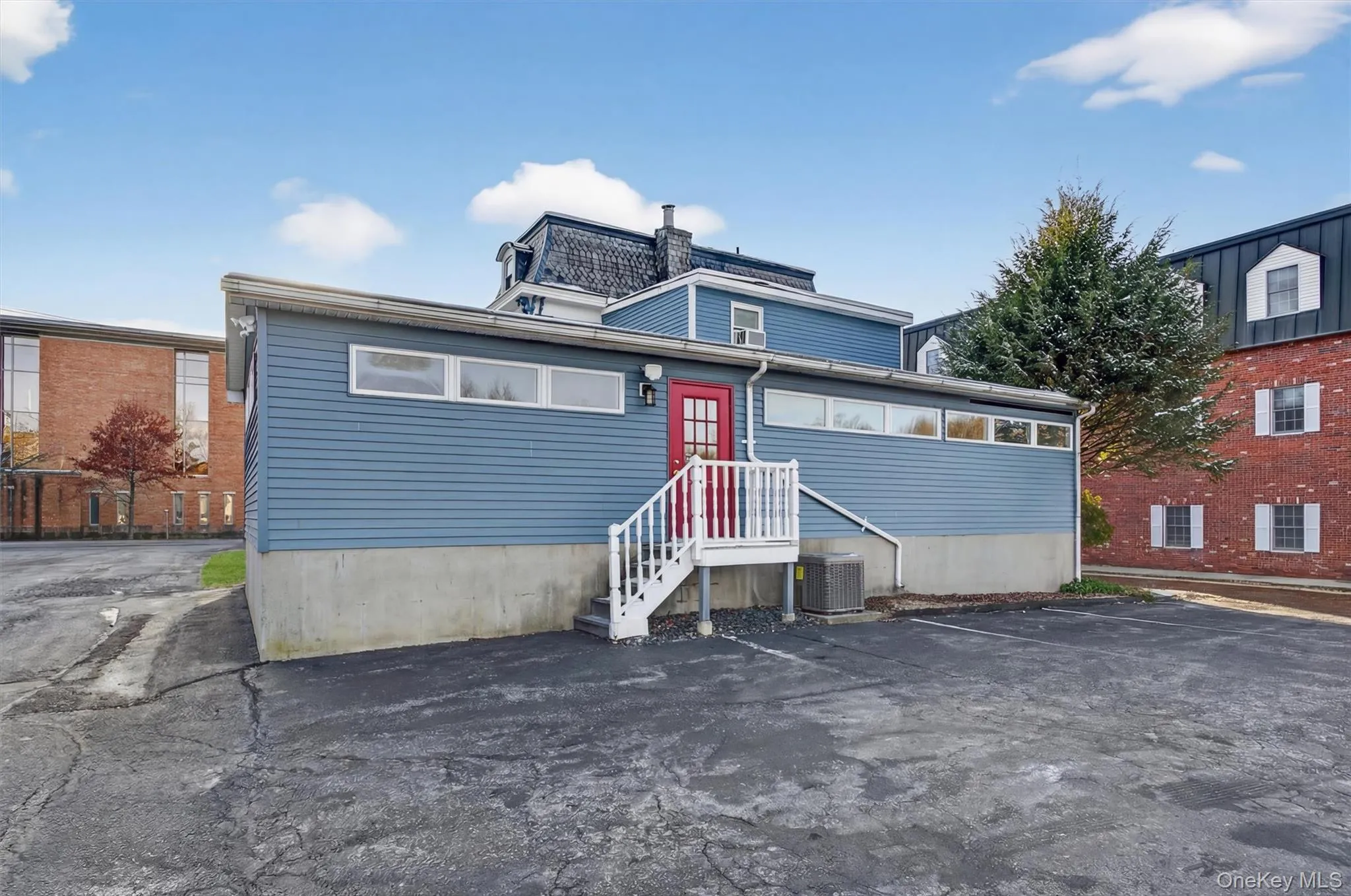 View of front of property featuring uncovered parking View of front of property featuring uncovered parking