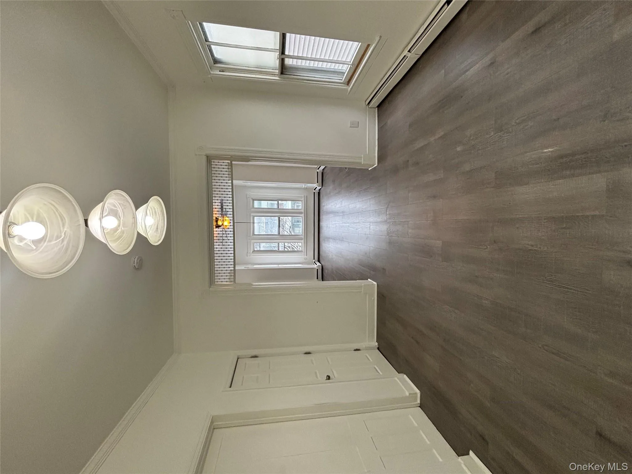 Unfurnished dining area featuring a baseboard heating unit, ornamental molding, and dark wood-type flooring Unfurnished dining area featuring a baseboard heating unit, ornamental molding, and dark wood-type flooring