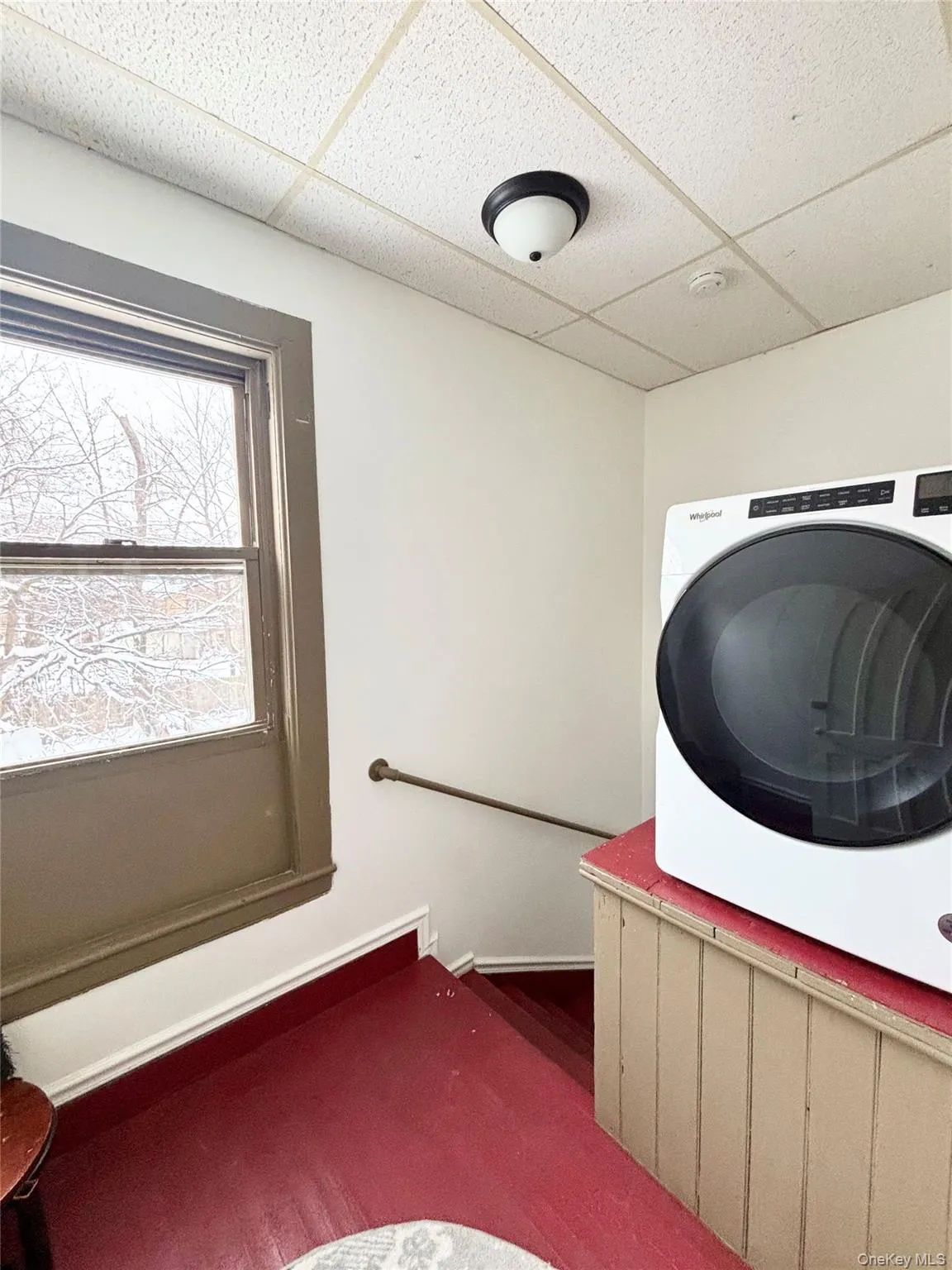 Washroom with washer / clothes dryer and a drop ceiling Washroom with washer / clothes dryer and a drop ceiling
