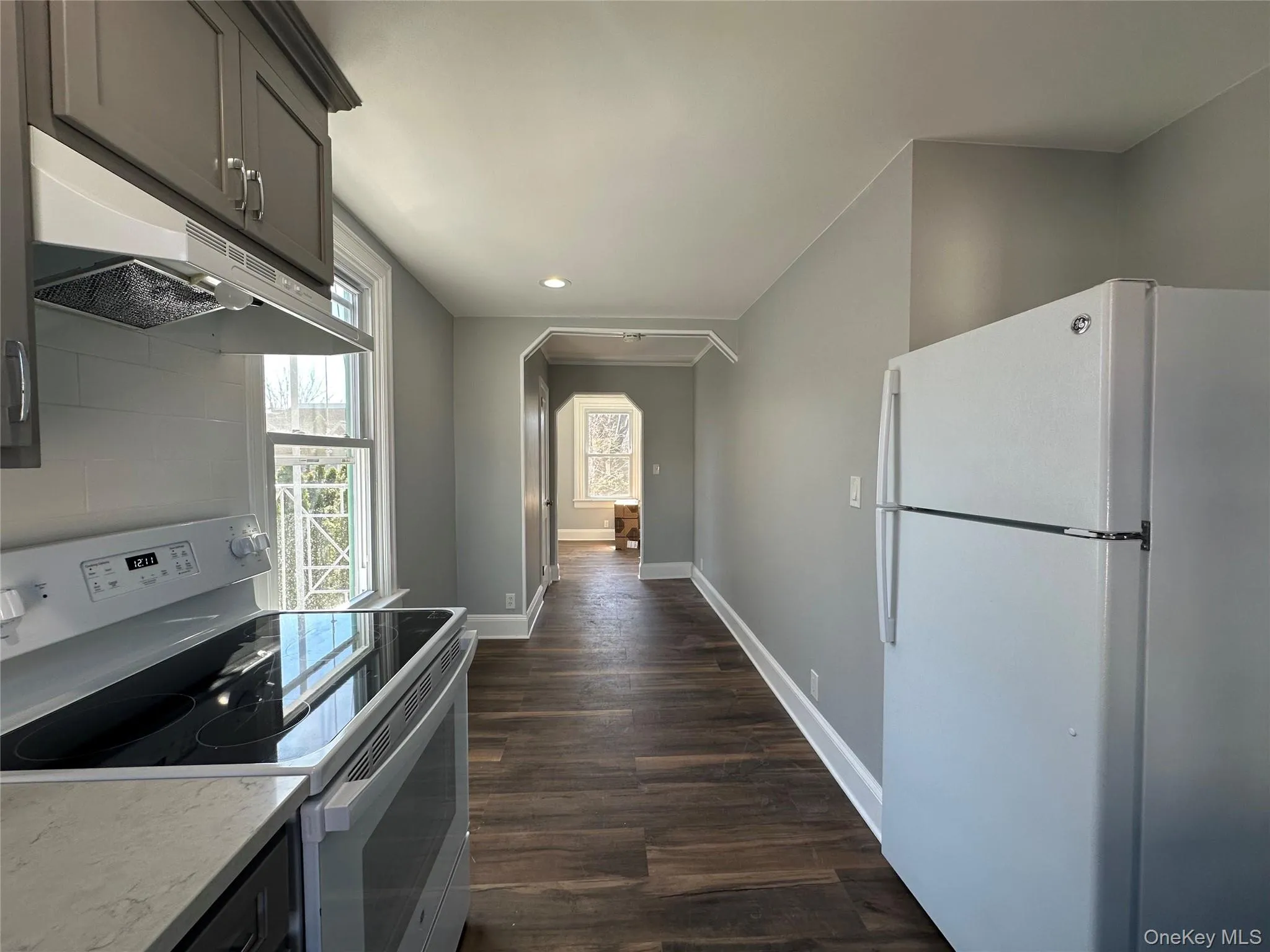 Kitchen with white appliances, light quartz countertops Kitchen with white appliances, light quartz countertops