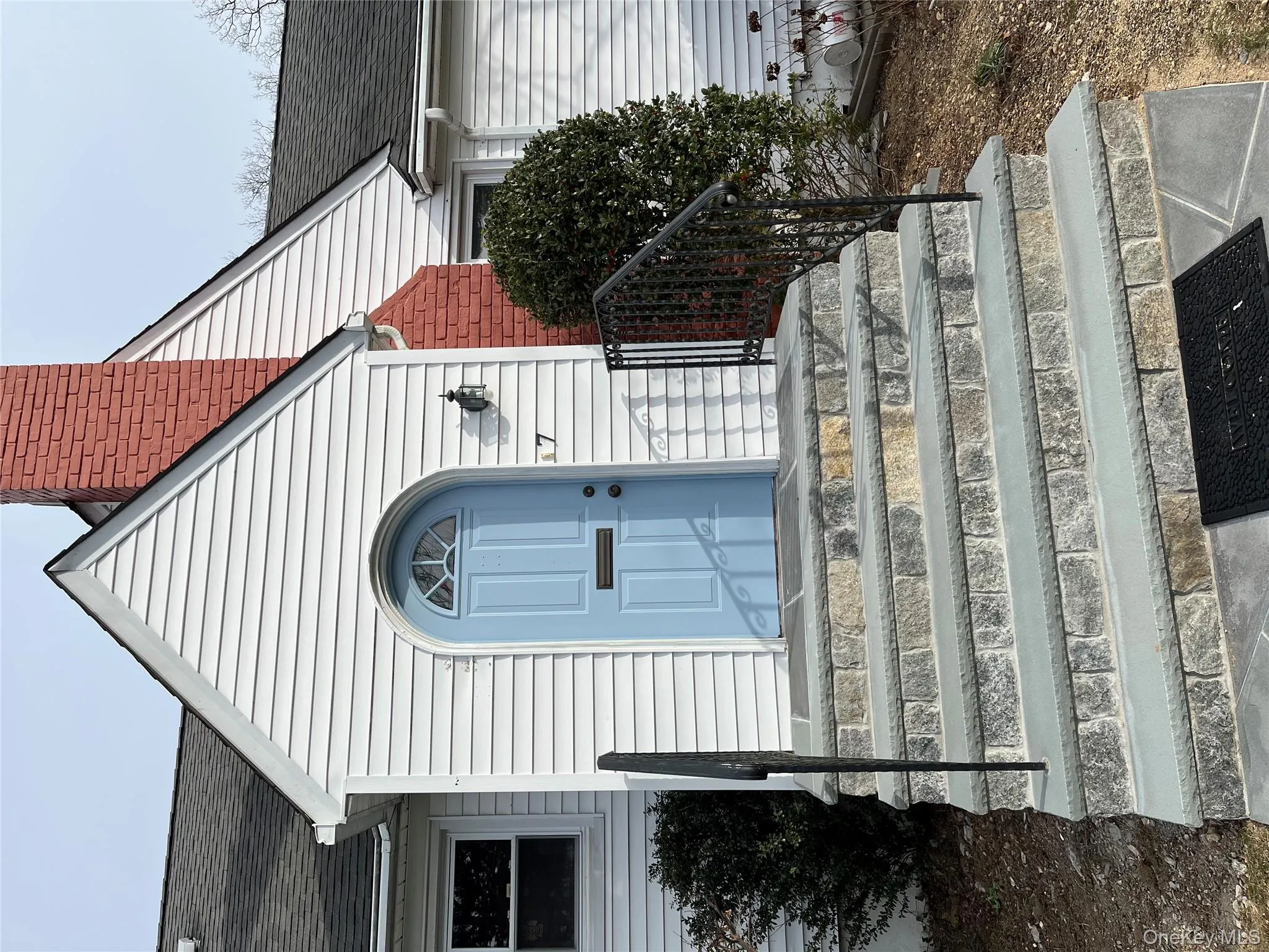 Doorway to property featuring a chimney and roof with shingles Doorway to property featuring a chimney and roof with shingles