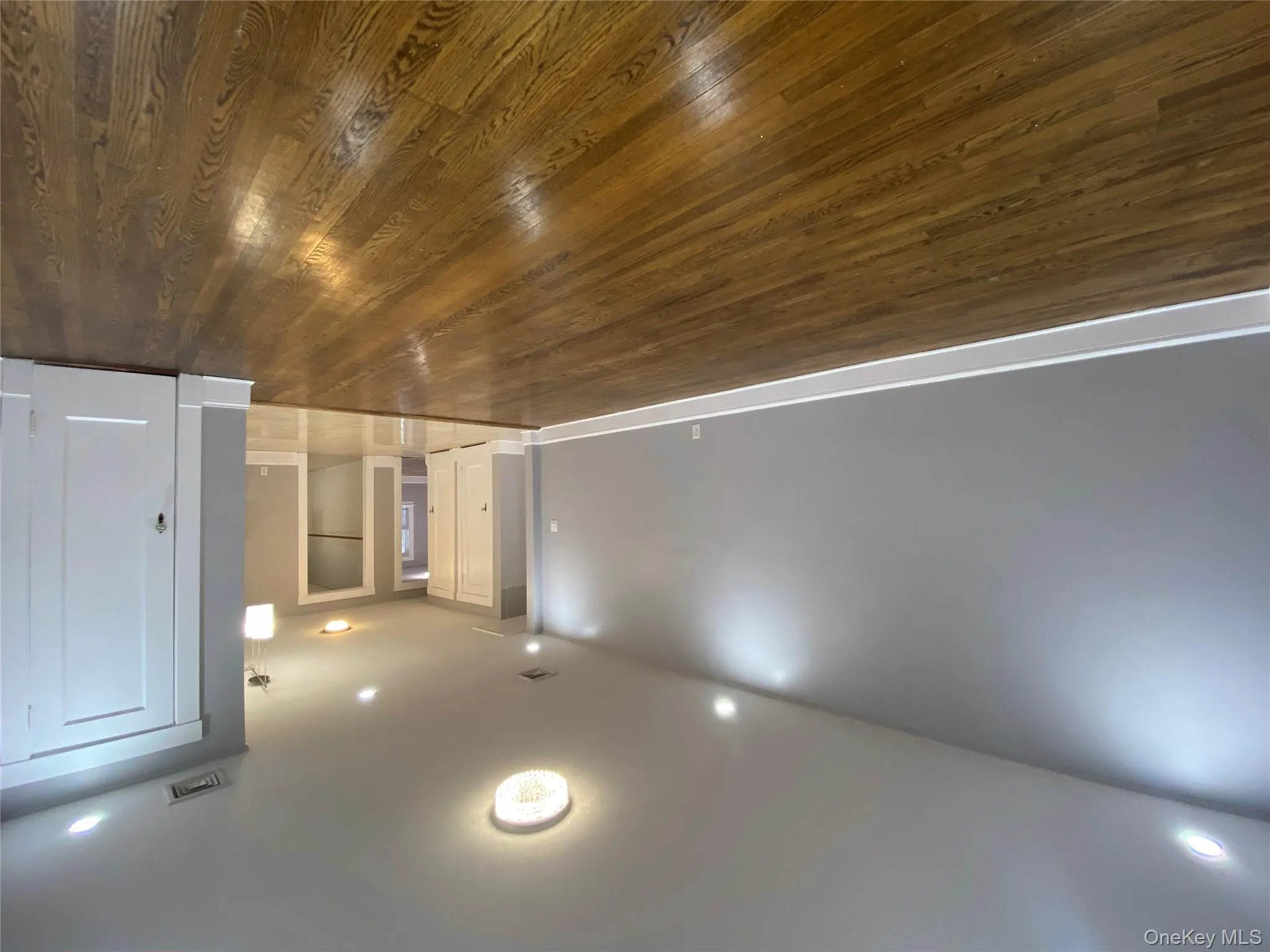 Unfurnished living room featuring recessed lighting and dark wood-style floors Unfurnished living room featuring recessed lighting and dark wood-style floors