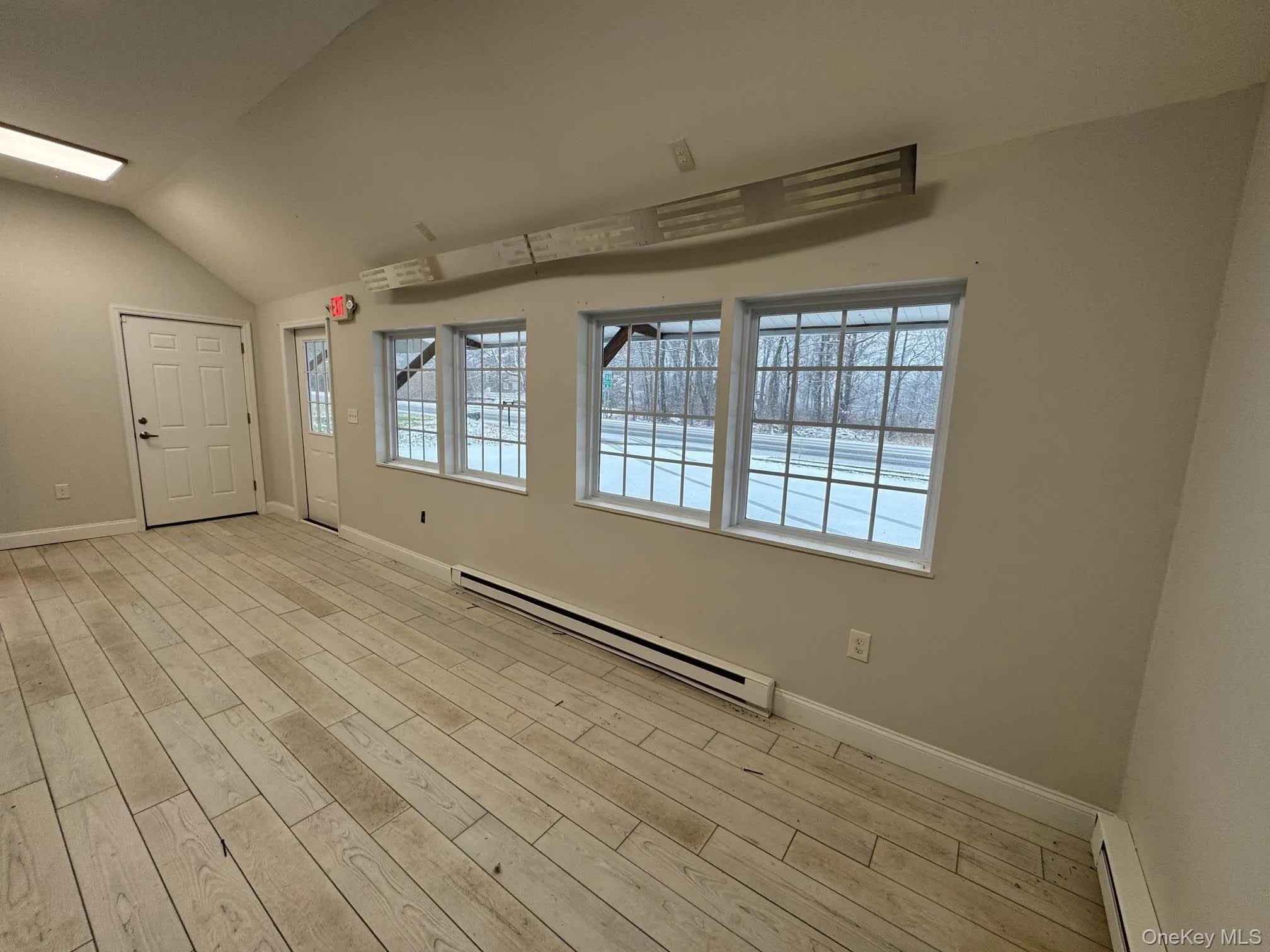 Interior open floor plan with view of the other front door and another side door with ramp access. Interior open floor plan with view of the other front door and another side door with ramp access.