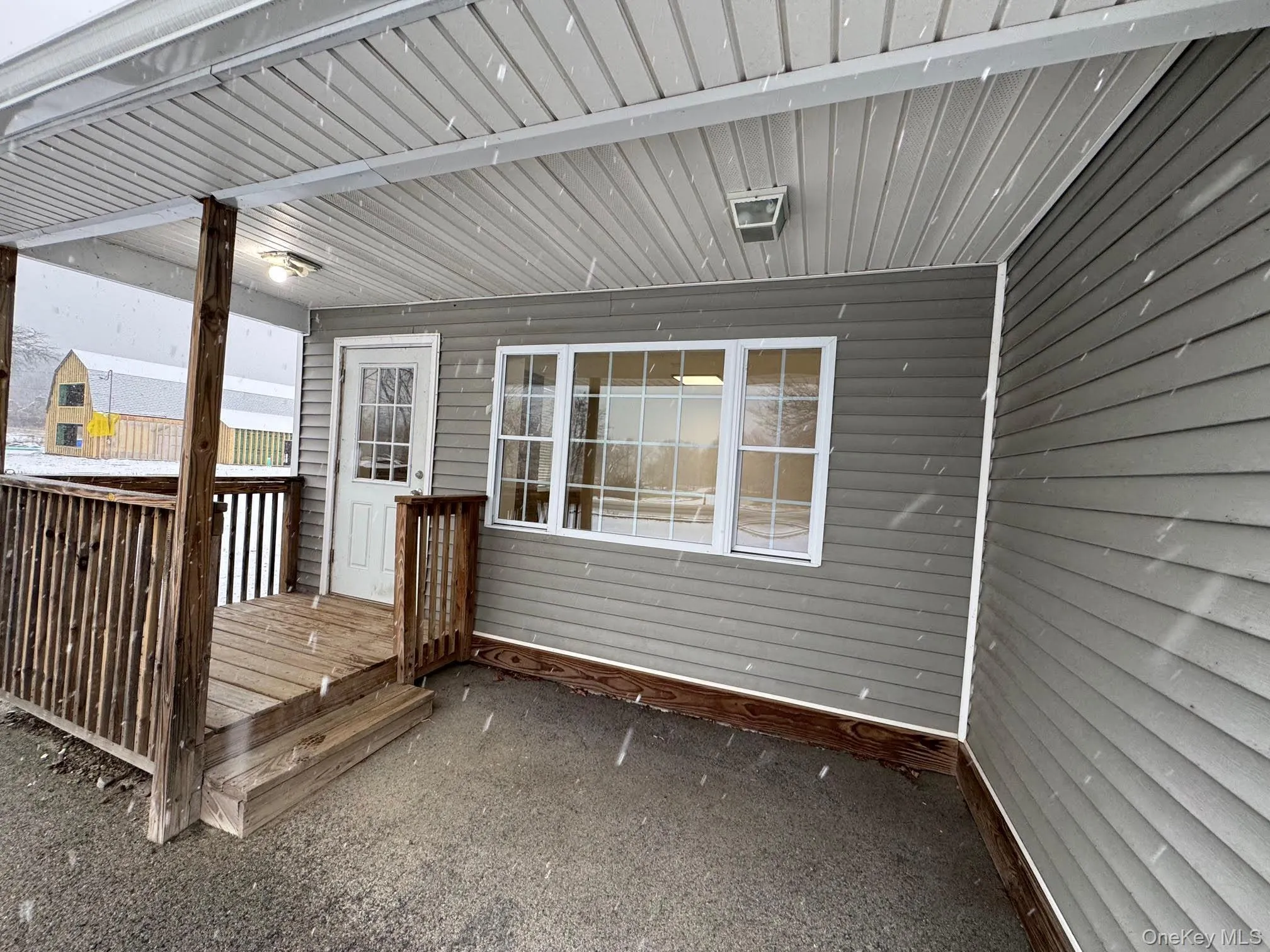 View of the front main entrance to the building with the covered front porch. View of the front main entrance to the building with the covered front porch.
