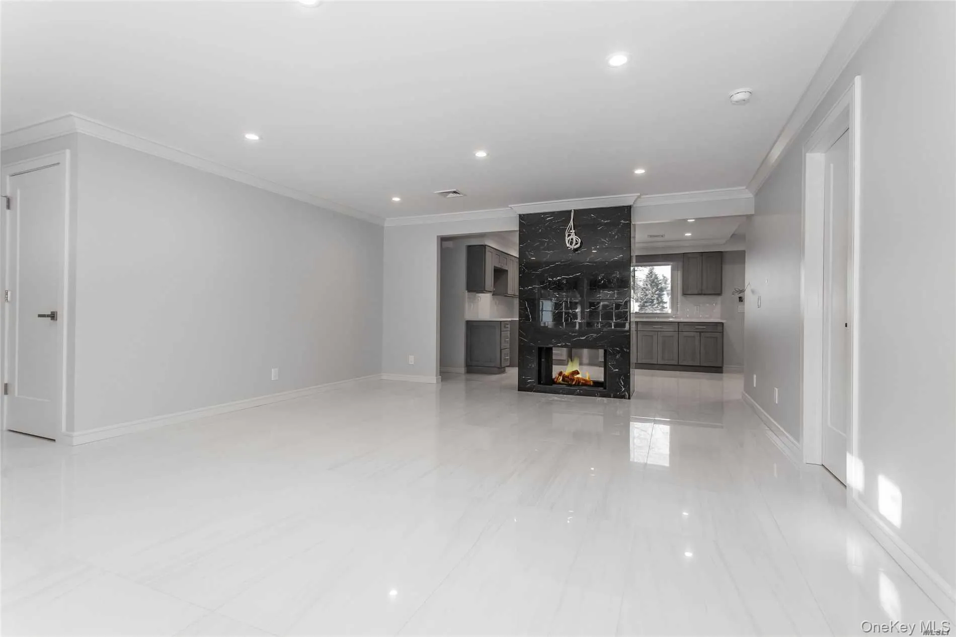 Large Living room with crown molding, a high end fireplace, and recessed lighting Large Living room with crown molding, a high end fireplace, and recessed lighting