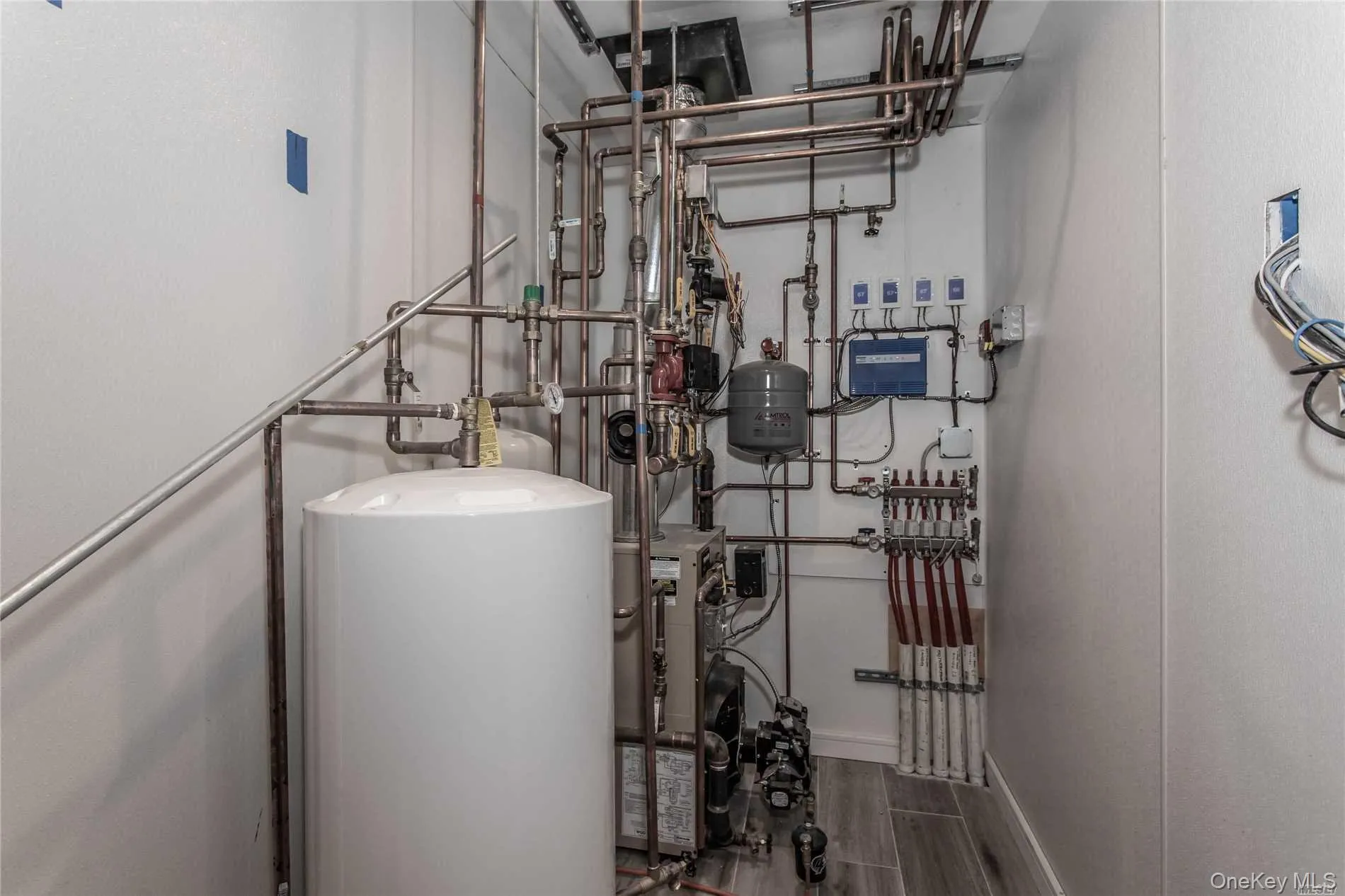 Utility room featuring water heater & Zoned Radiant Heat Flooring Utility room featuring water heater & Zoned Radiant Heat Flooring