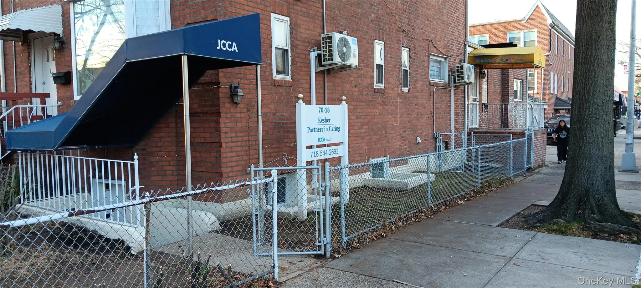 View of property exterior with brick siding and a gate View of property exterior with brick siding and a gate