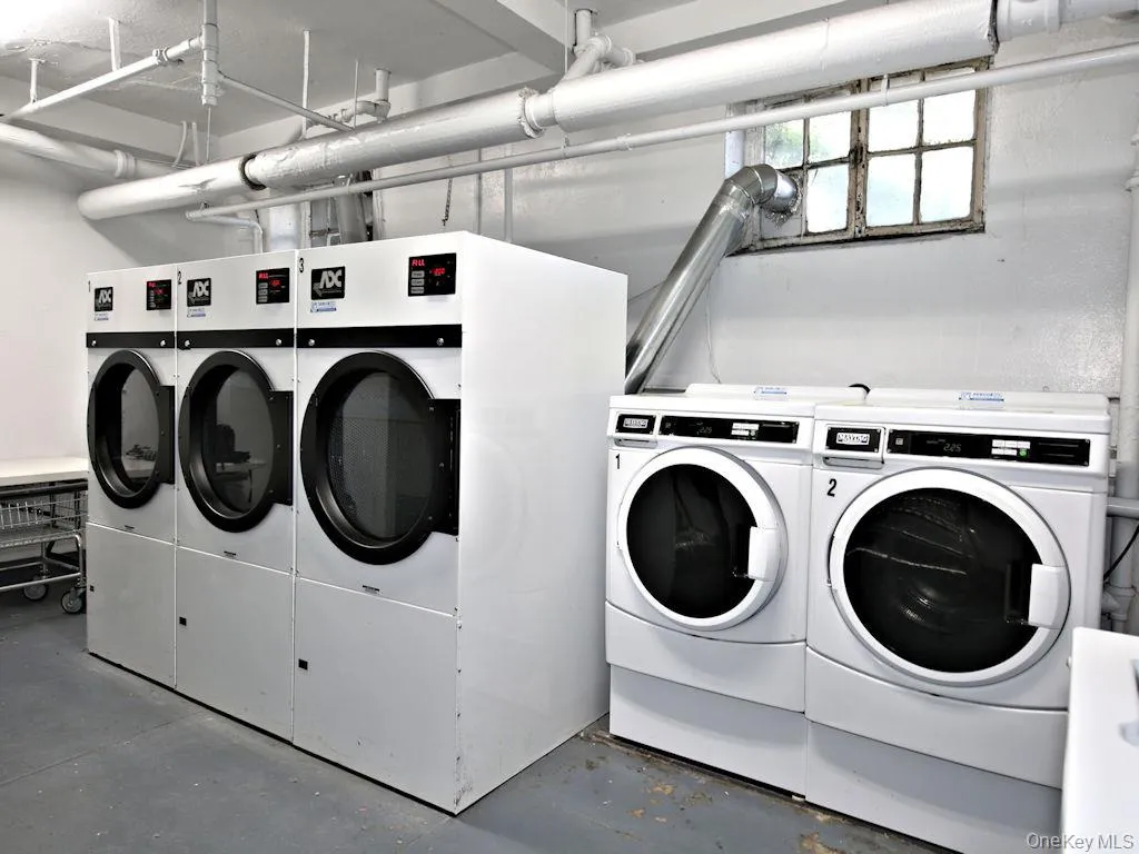 Communal laundry room featuring washer and clothes dryer Communal laundry room featuring washer and clothes dryer