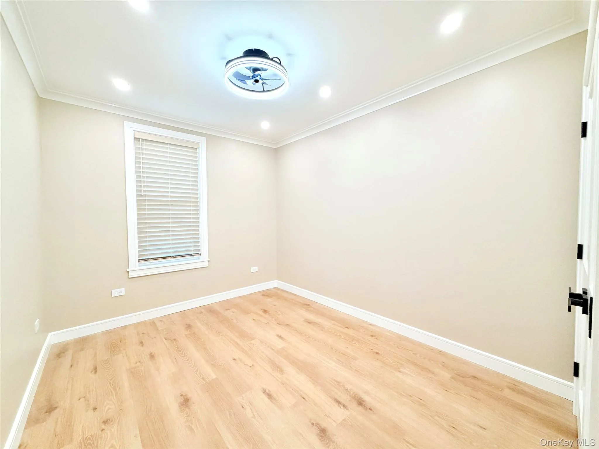 Empty room with light wood finished floors, recessed lighting, and ornamental molding Empty room with light wood finished floors, recessed lighting, and ornamental molding