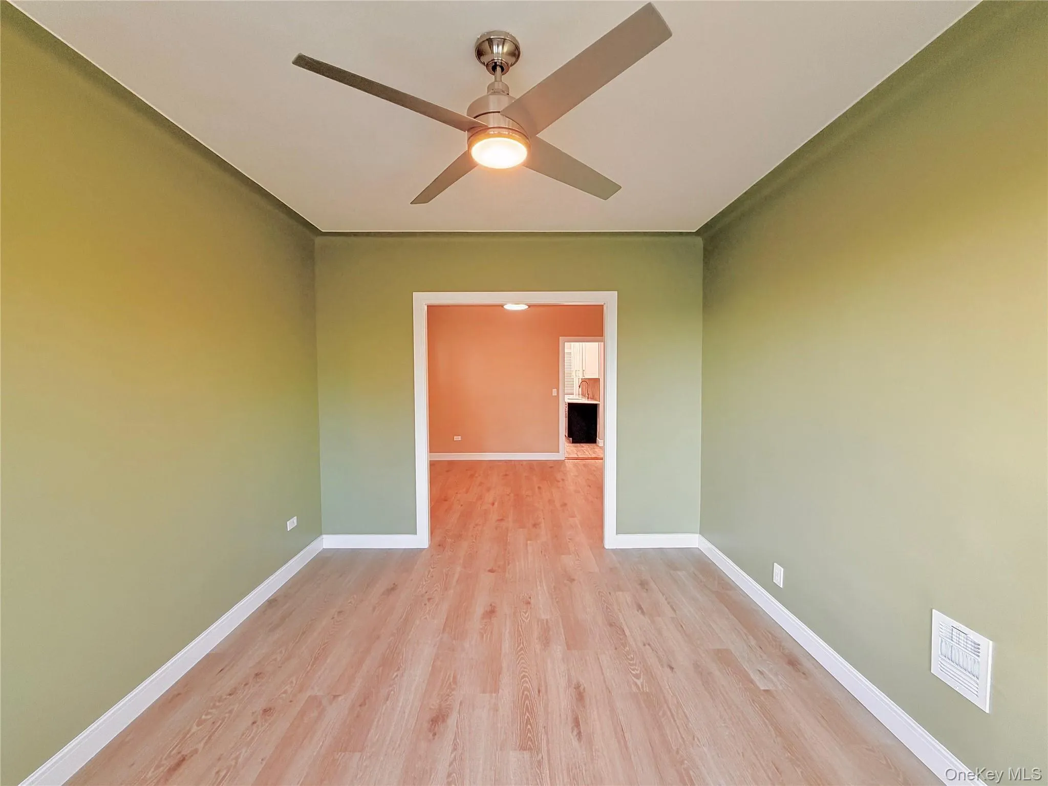Unfurnished room with light wood-style flooring and ceiling fan Unfurnished room with light wood-style flooring and ceiling fan