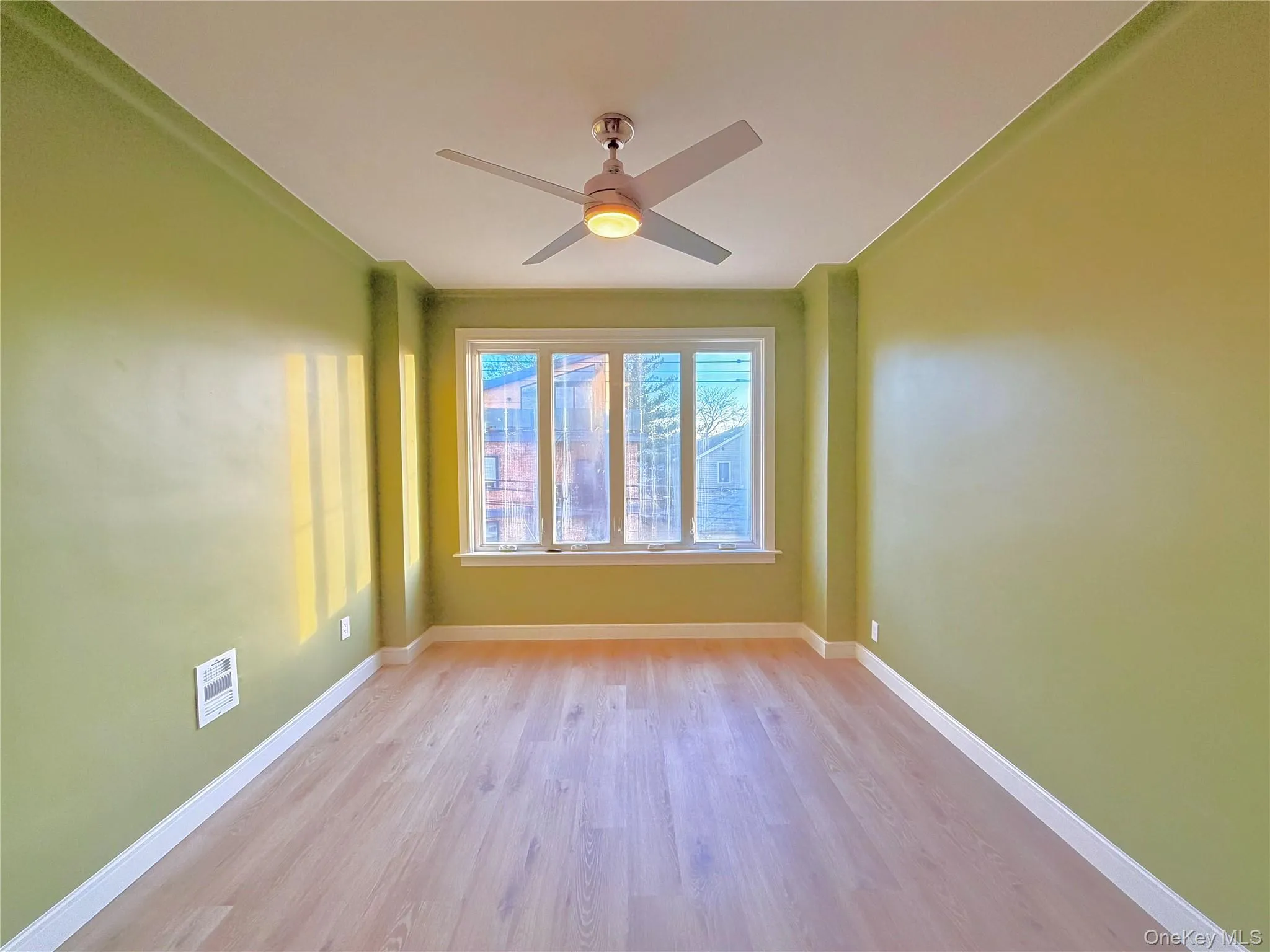 Unfurnished room featuring light wood-type flooring and a ceiling fan Unfurnished room featuring light wood-type flooring and a ceiling fan