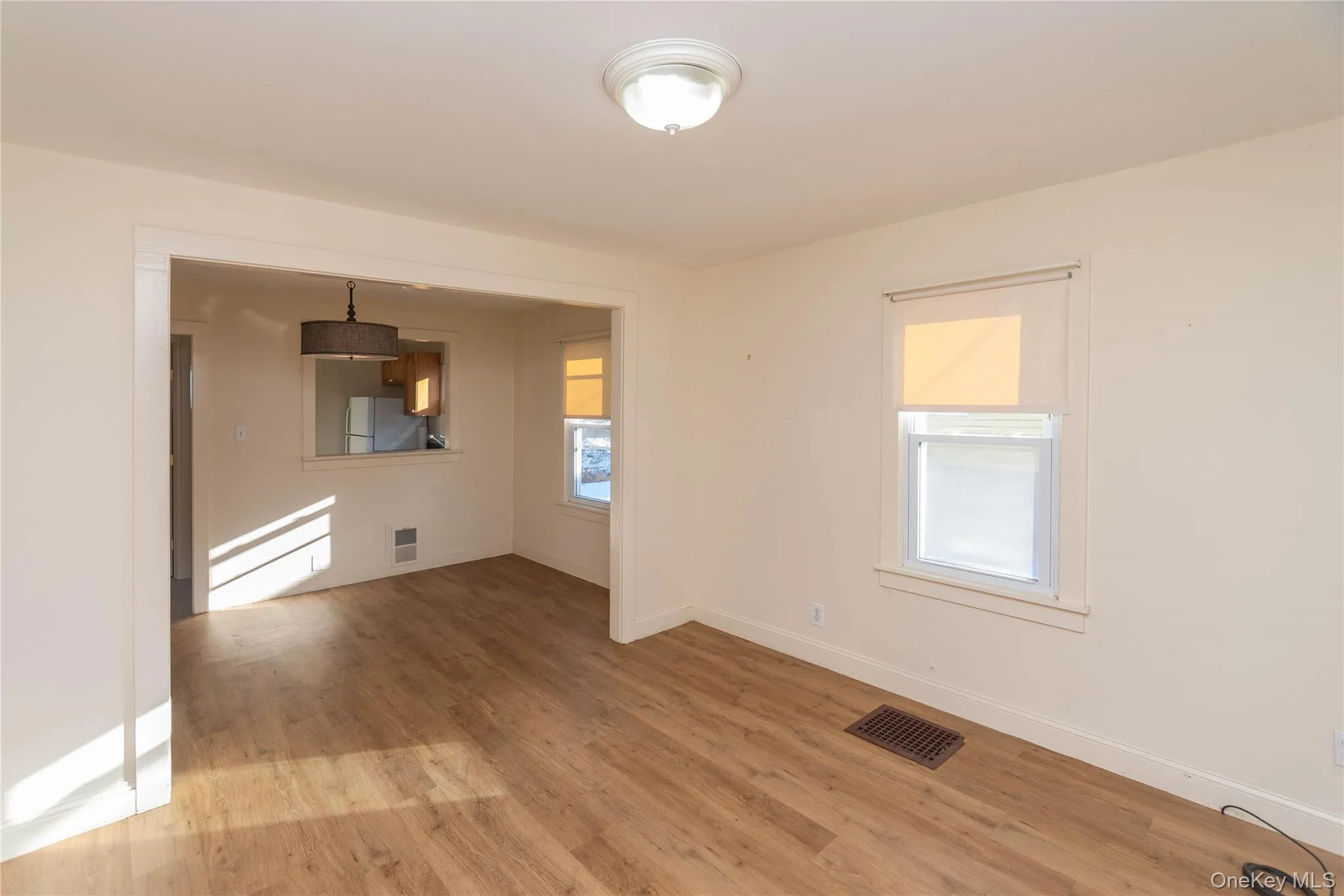 Unfurnished room with light wood-type flooring and baseboards Unfurnished room with light wood-type flooring and baseboards