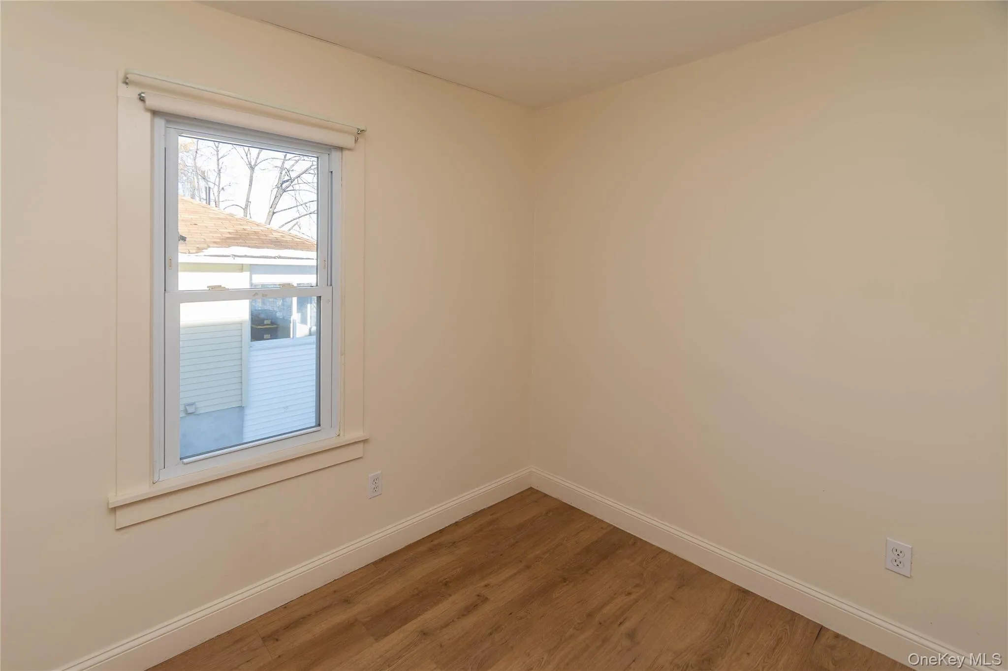 Empty room featuring baseboards and wood finished floors Empty room featuring baseboards and wood finished floors