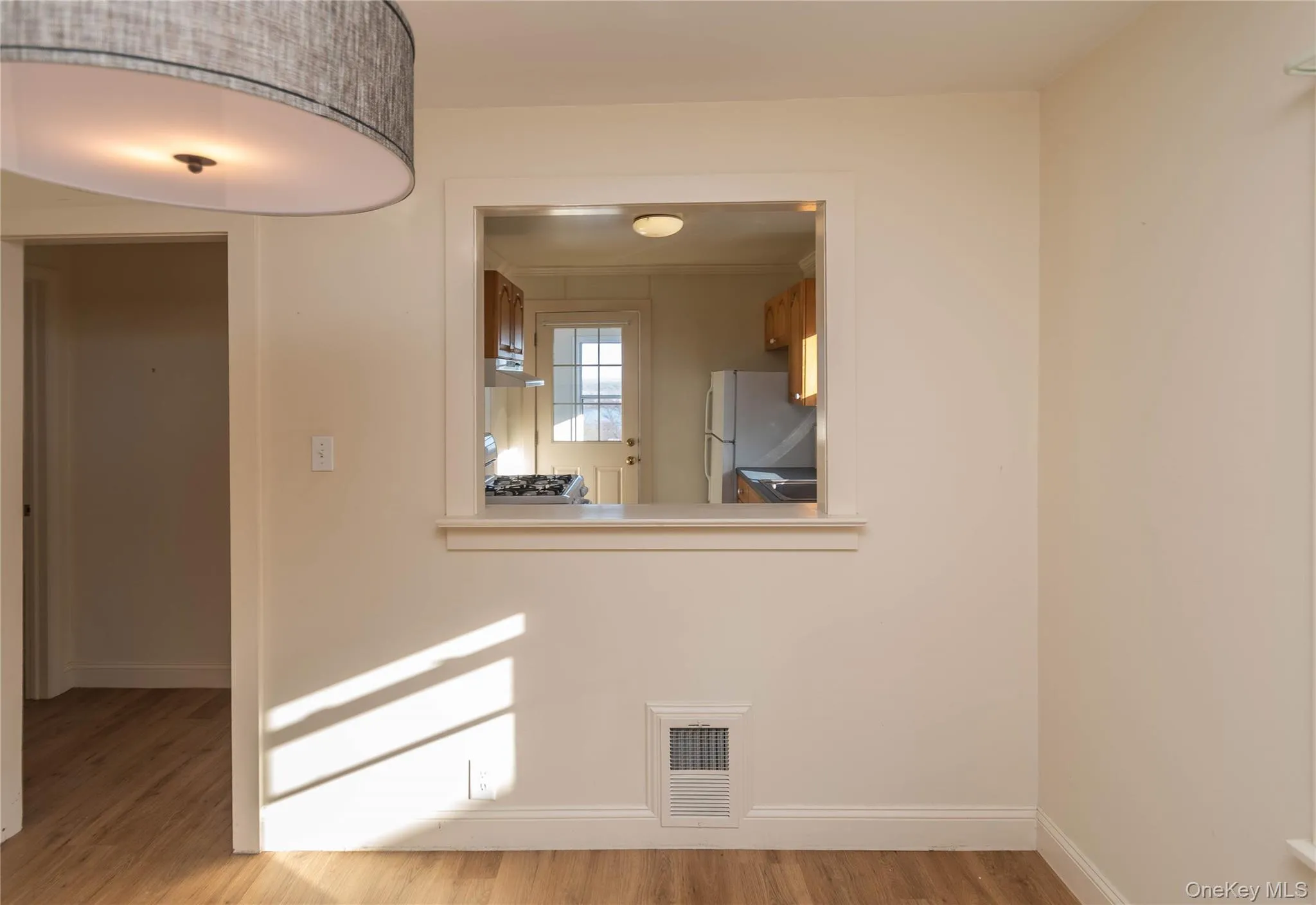 Spare room with baseboards and light wood finished floors Spare room with baseboards and light wood finished floors