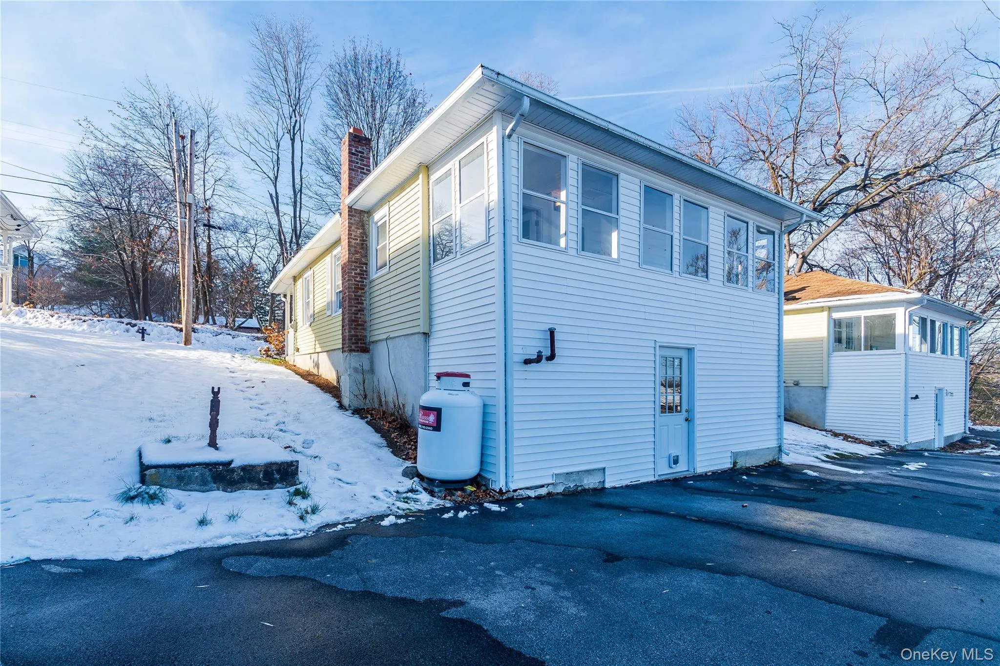 Snow covered property featuring a chimney Snow covered property featuring a chimney