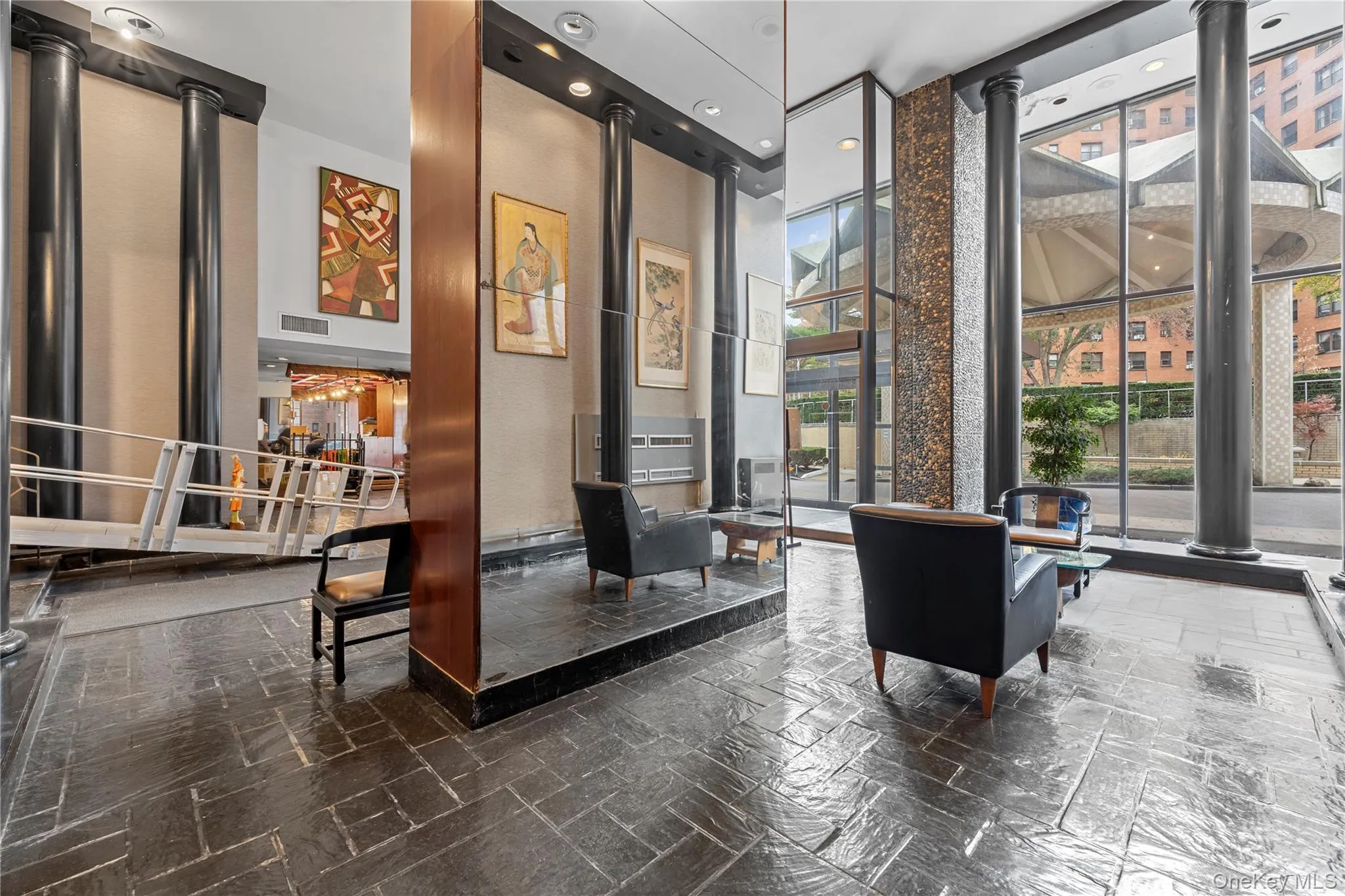 Building lobby featuring a wall of windows and a high ceiling Building lobby featuring a wall of windows and a high ceiling
