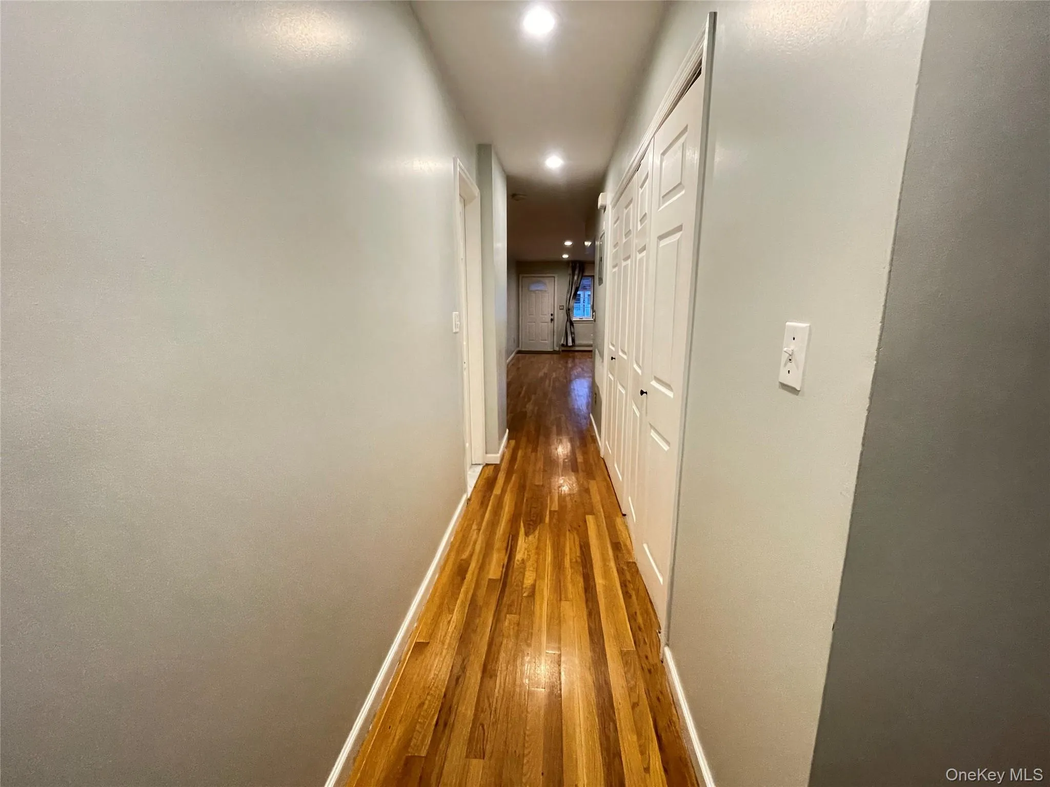 Hall featuring dark wood-type flooring and recessed lighting Hall featuring dark wood-type flooring and recessed lighting