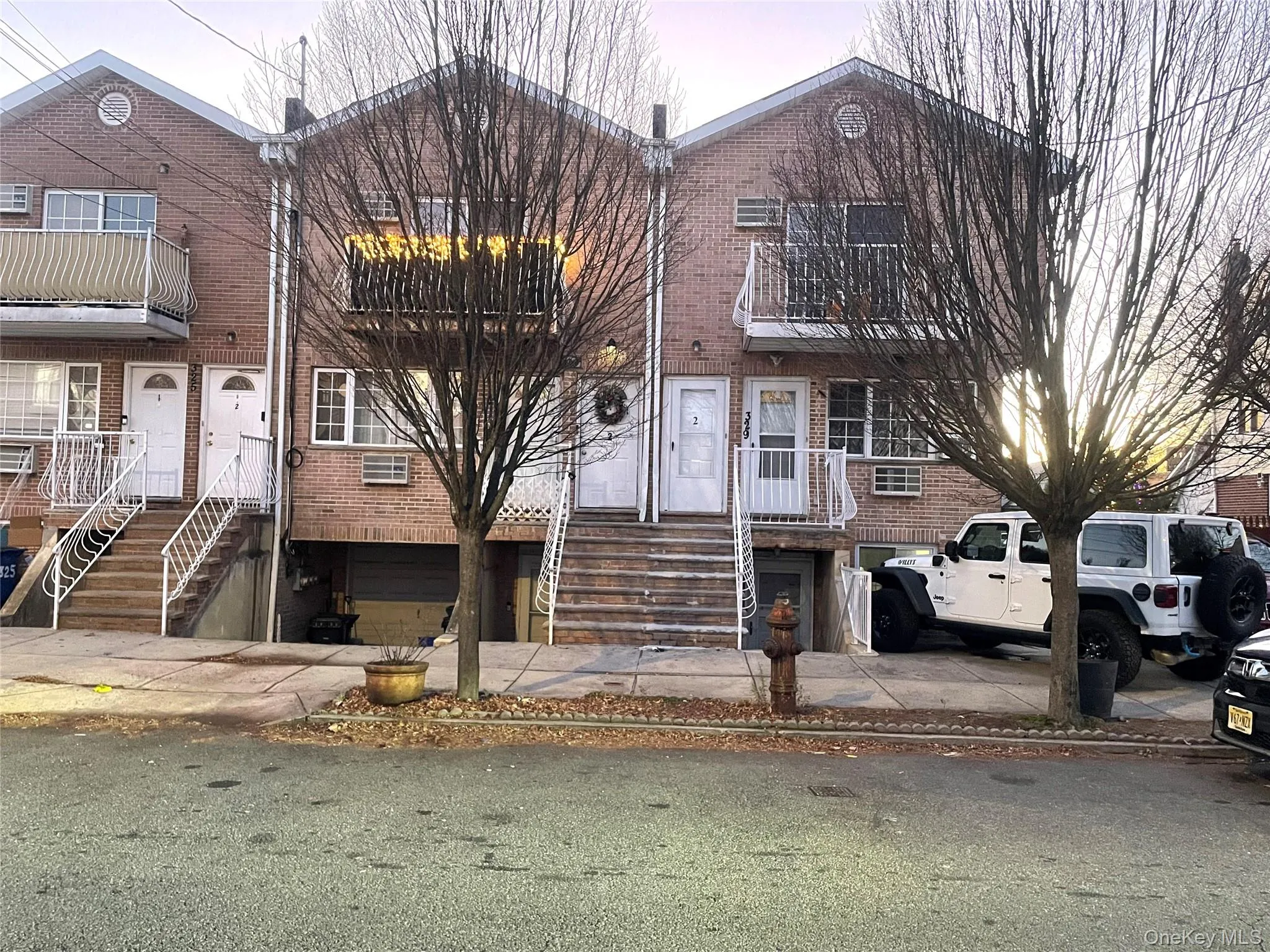 Traditional-style home featuring brick siding, an attached garage, and a balcony Traditional-style home featuring brick siding, an attached garage, and a balcony