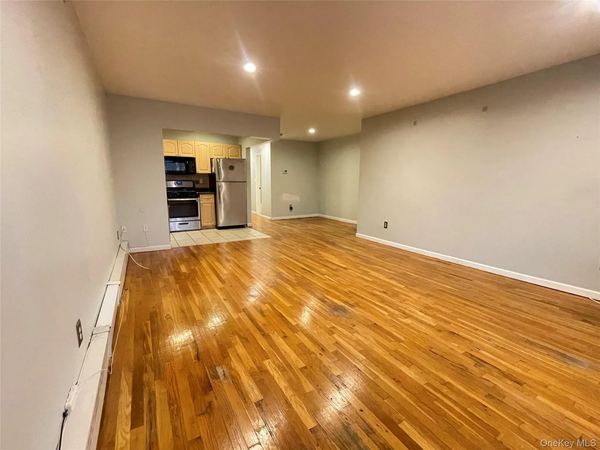 Unfurnished living room with light wood-style floors and recessed lighting Unfurnished living room with light wood-style floors and recessed lighting