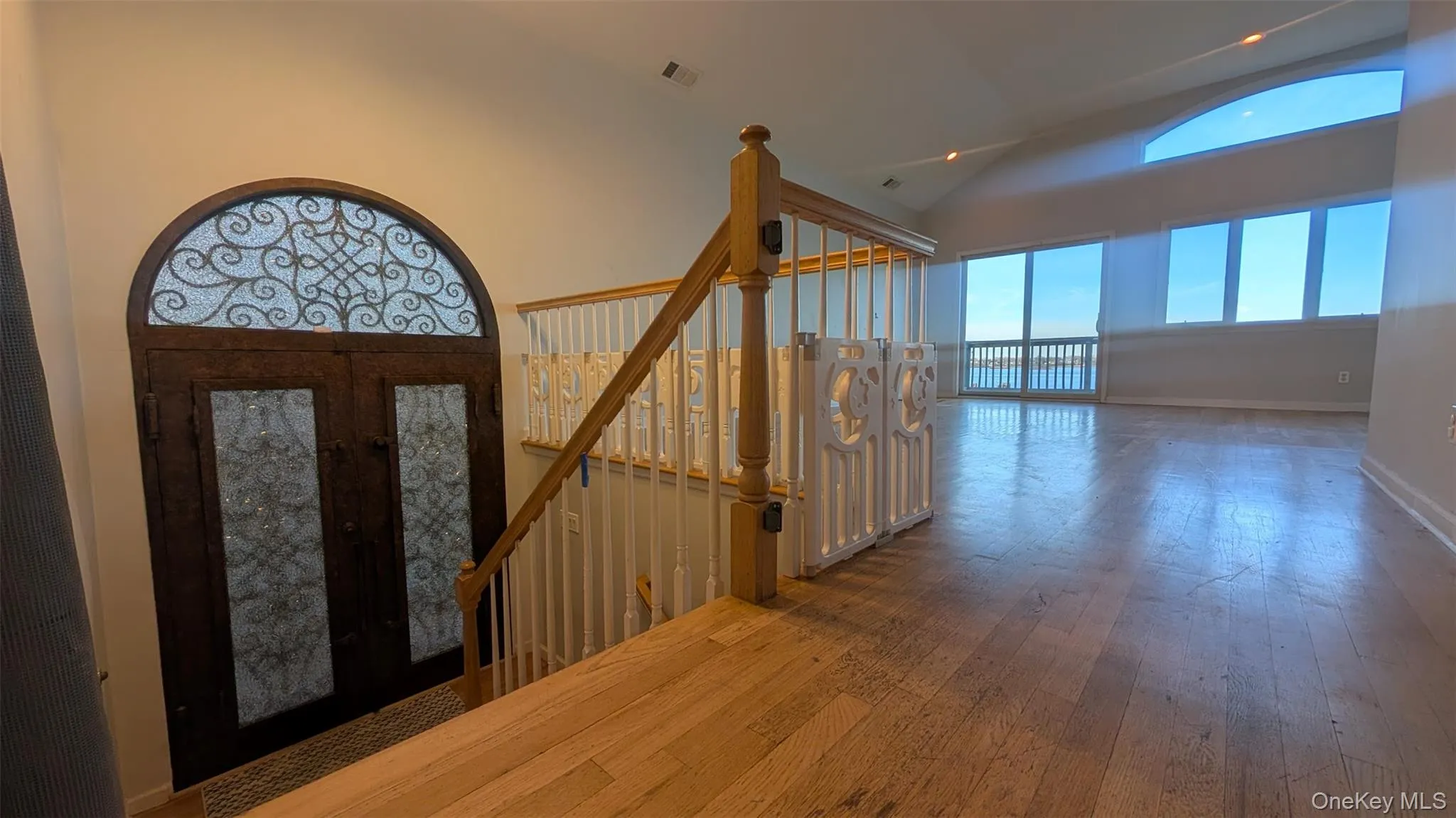 Entryway with french doors, dark wood-style floors, and high vaulted ceiling Entryway with french doors, dark wood-style floors, and high vaulted ceiling