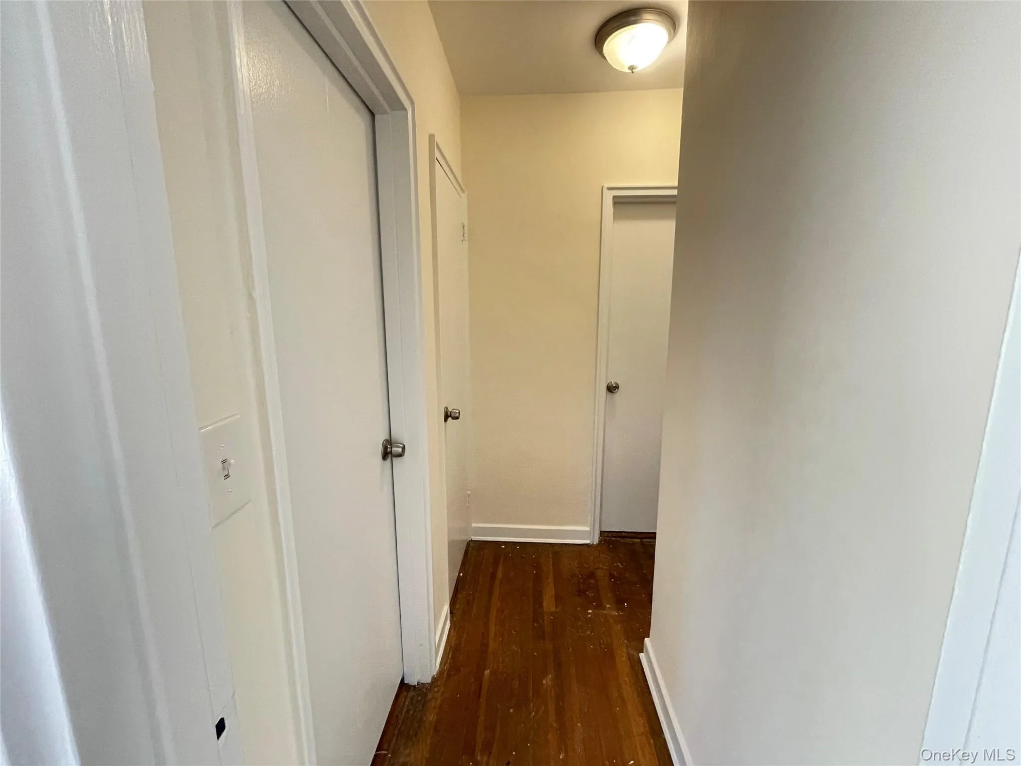 Hall with baseboards and dark wood-type flooring Hall with baseboards and dark wood-type flooring