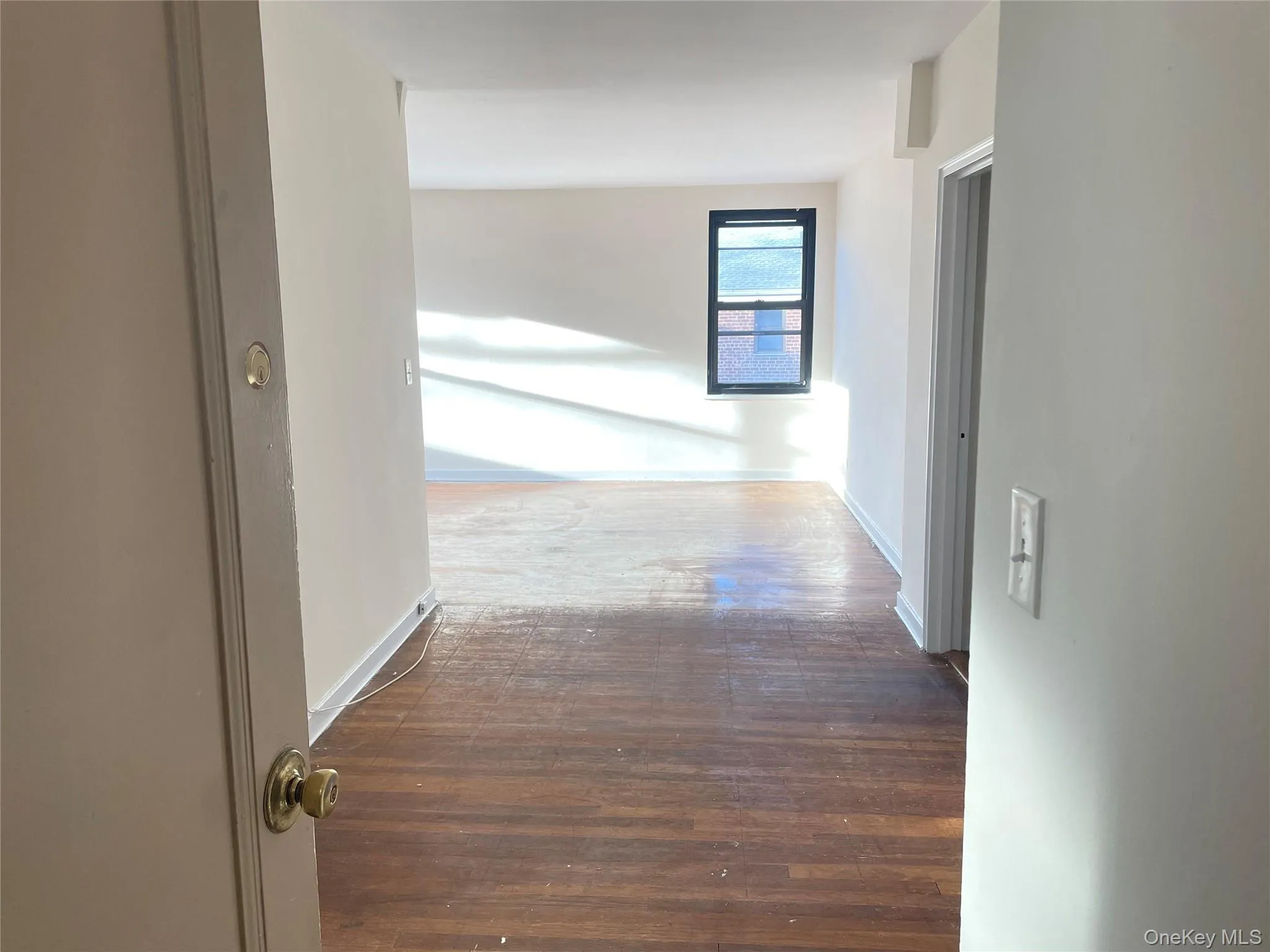 Corridor with dark wood-style flooring and baseboards Corridor with dark wood-style flooring and baseboards