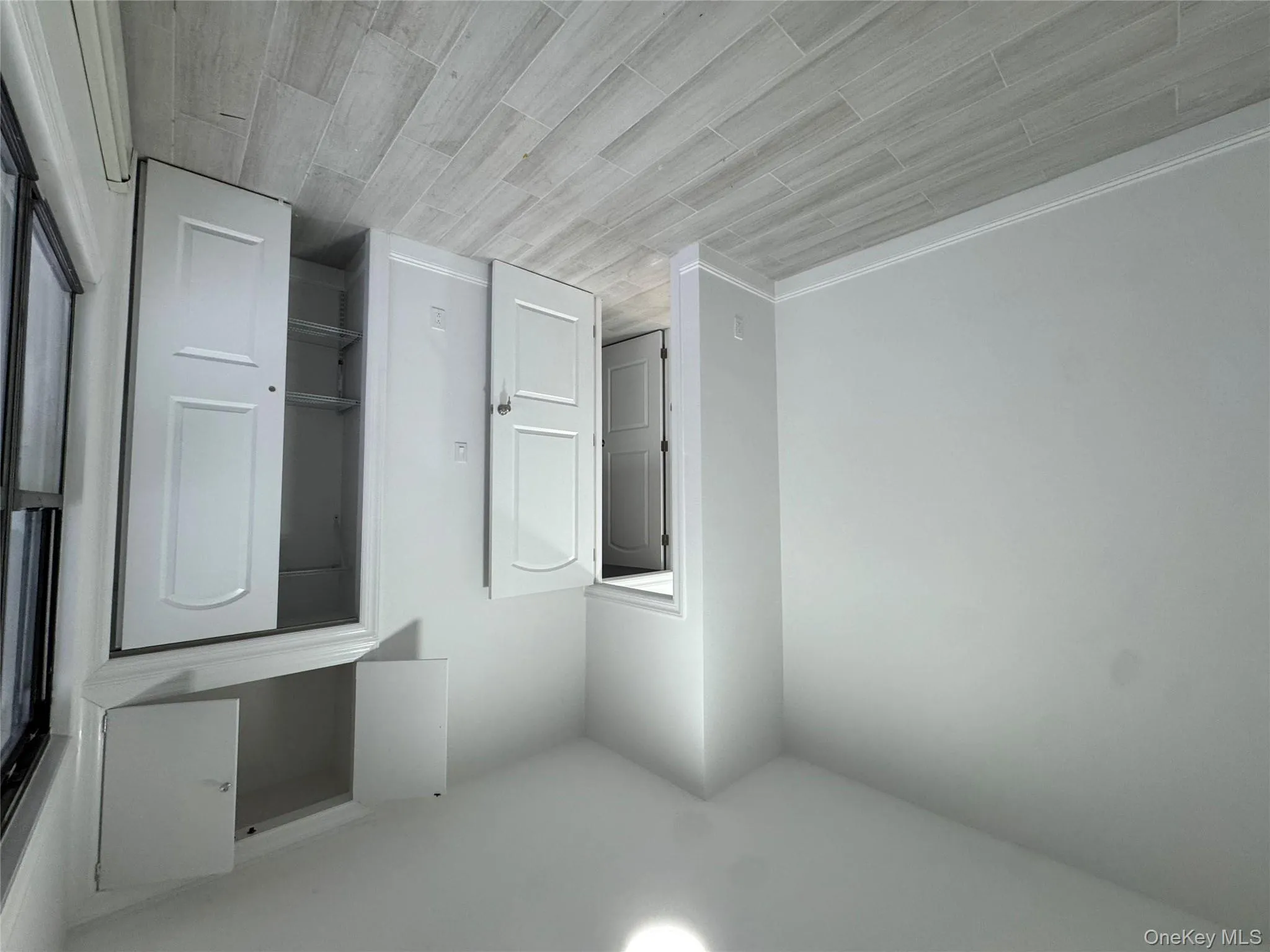 Unfurnished bedroom featuring a closet and wood tiled floors Unfurnished bedroom featuring a closet and wood tiled floors