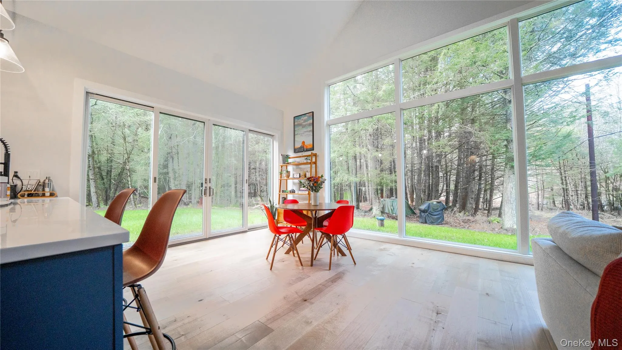 Sunroom / solarium with lofted ceiling, plenty of natural light, and hardwood / wood-style flooring Sunroom / solarium with lofted ceiling, plenty of natural light, and hardwood / wood-style flooring