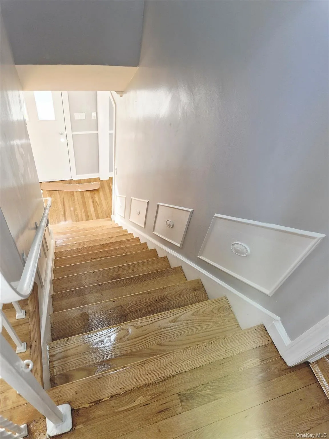Staircase featuring wood finished floors Staircase featuring wood finished floors