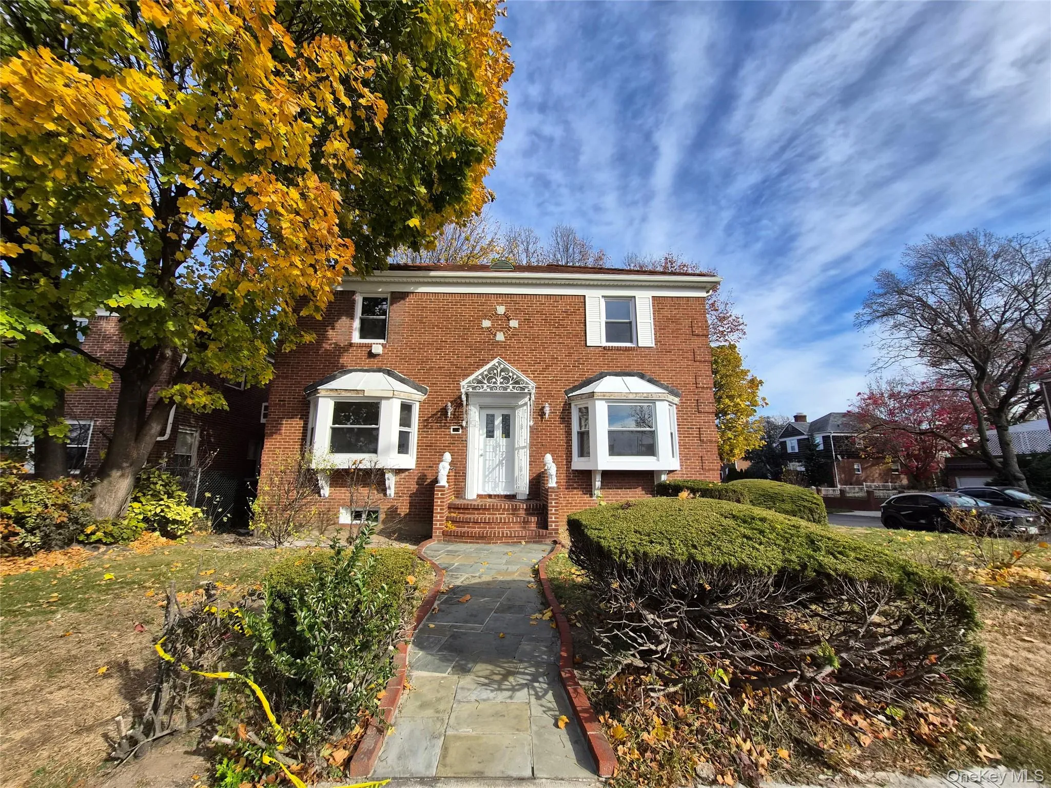 Colonial house featuring brick siding Colonial house featuring brick siding