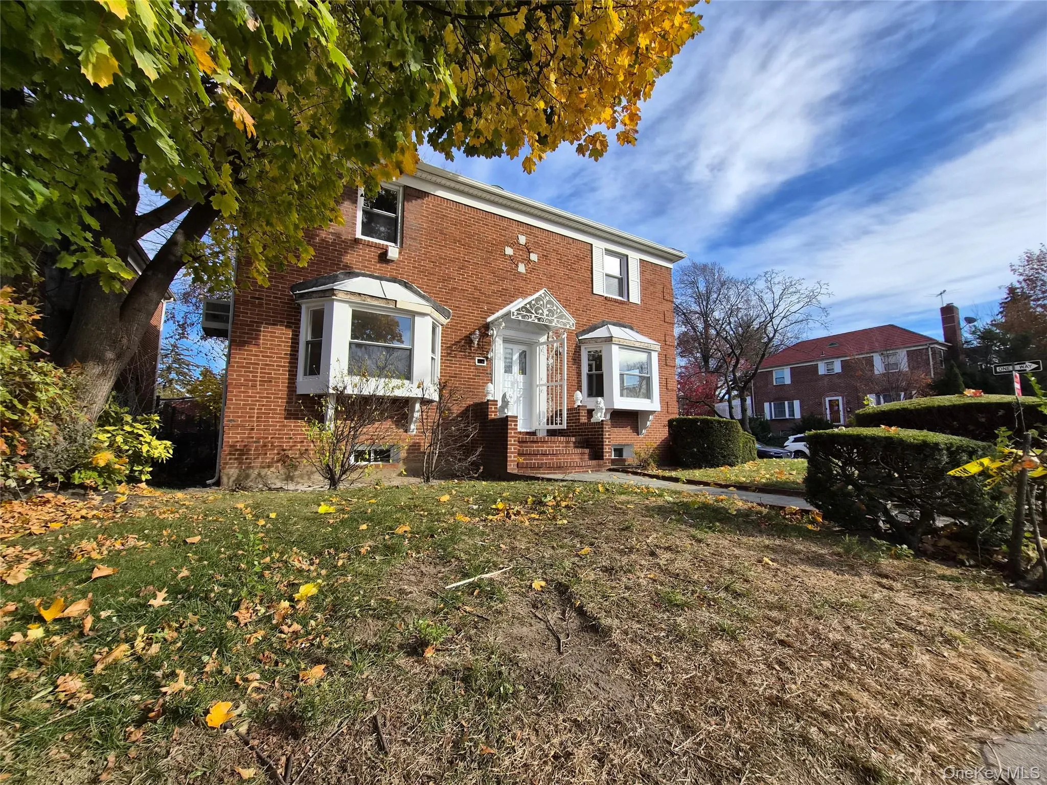 Colonial inspired home with brick siding and a front lawn Colonial inspired home with brick siding and a front lawn