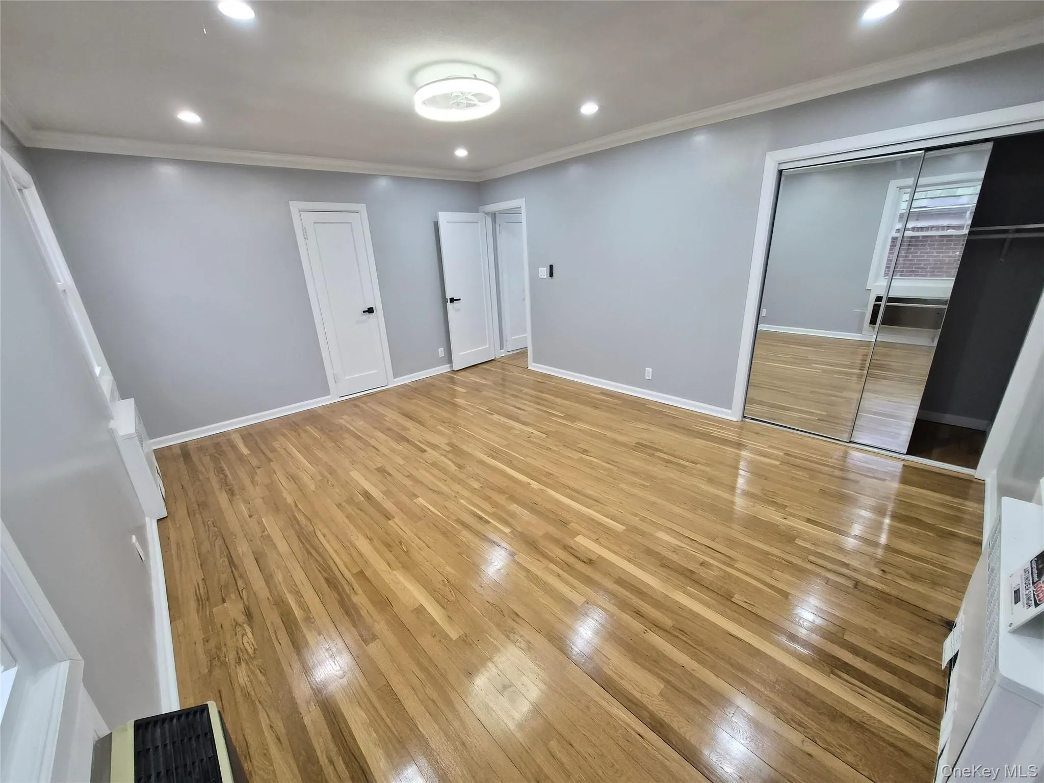 Unfurnished bedroom with light wood-style floors, recessed lighting, and ornamental molding Unfurnished bedroom with light wood-style floors, recessed lighting, and ornamental molding