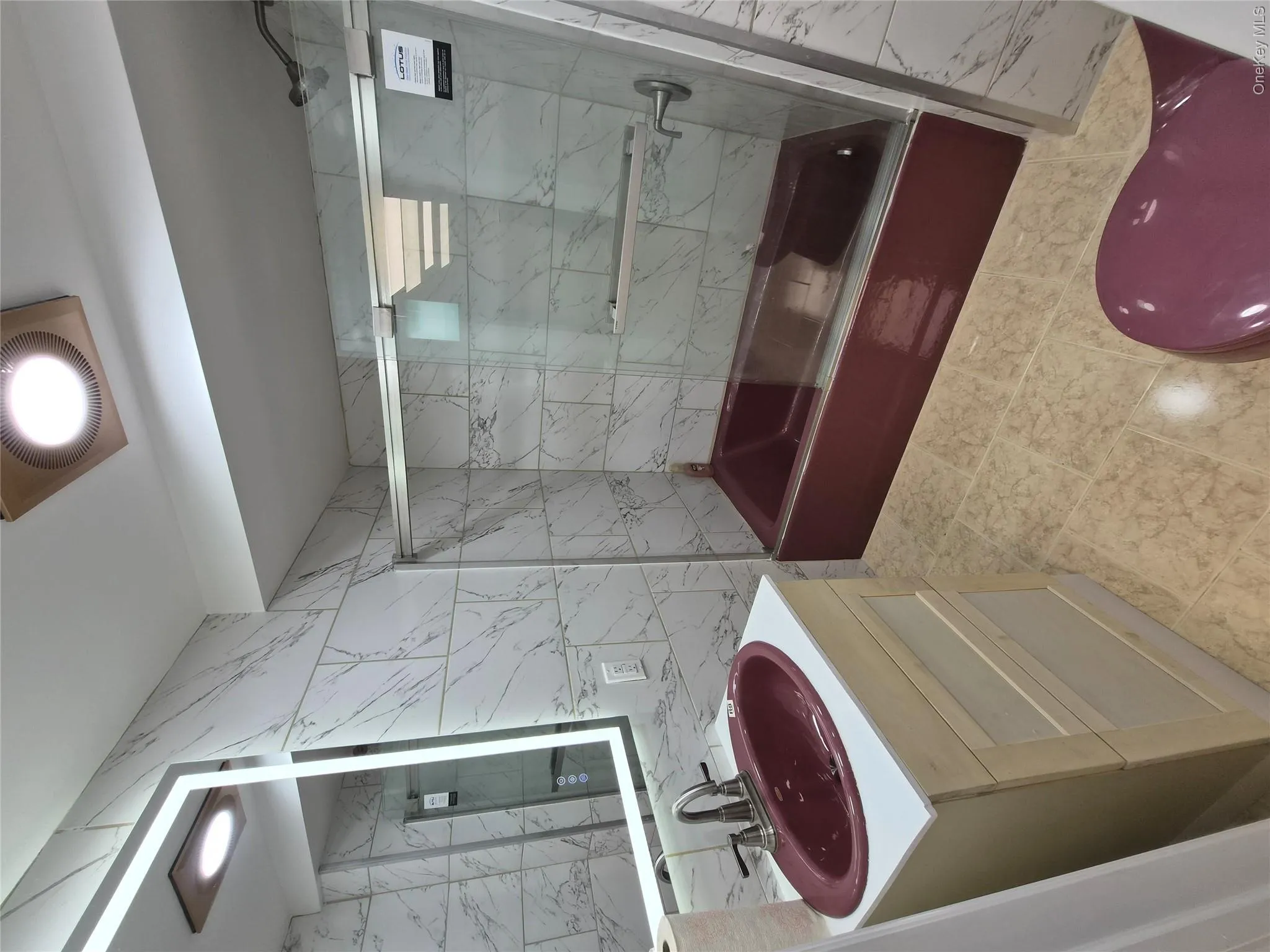 Full bathroom featuring tile walls, combined bath / shower with glass door, and vanity Full bathroom featuring tile walls, combined bath / shower with glass door, and vanity