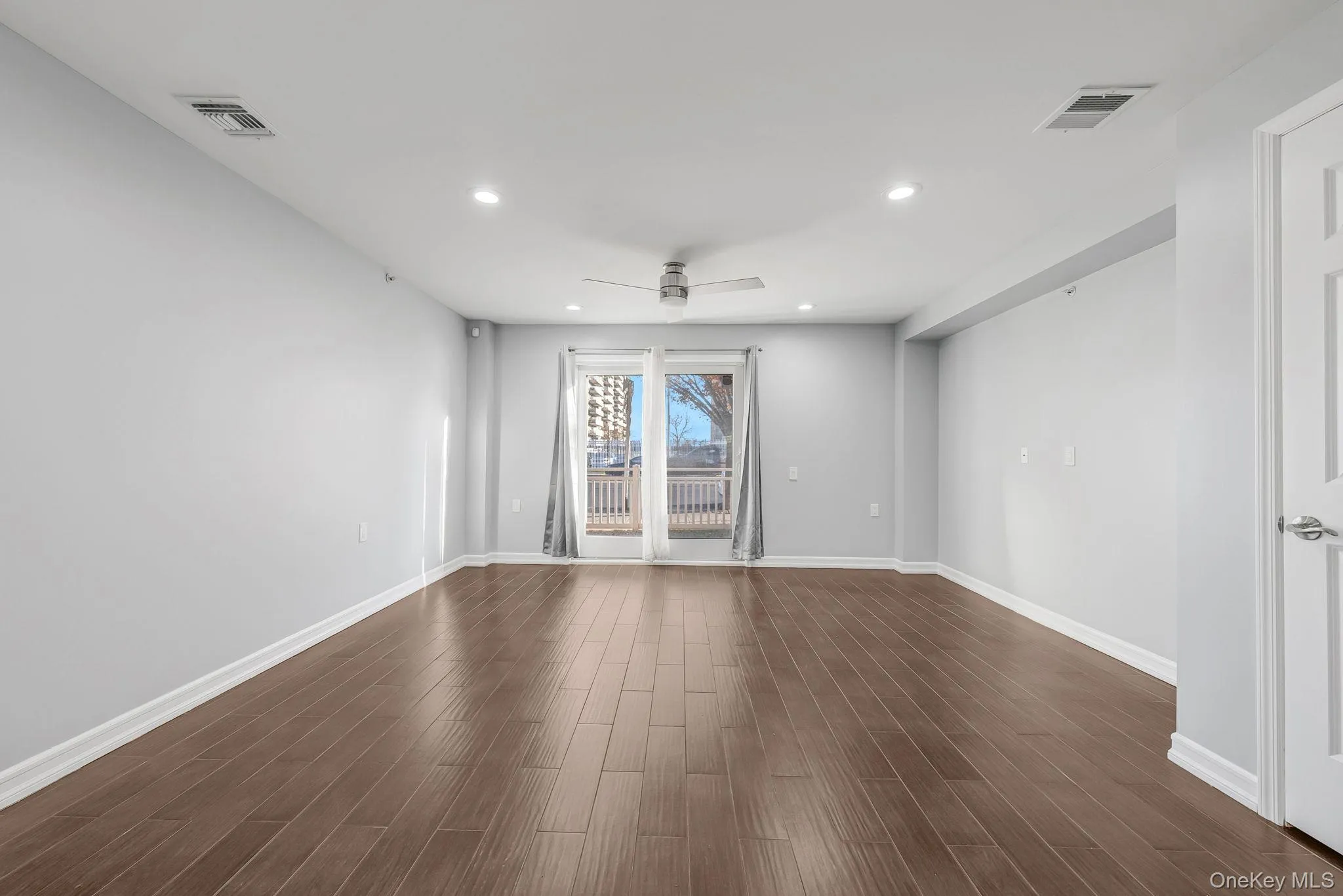 Unfurnished room with recessed lighting, dark wood-style flooring, and a ceiling fan Unfurnished room with recessed lighting, dark wood-style flooring, and a ceiling fan