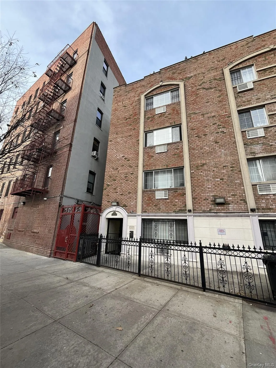 View of apartment building / complex featuring a fenced front yard View of apartment building / complex featuring a fenced front yard