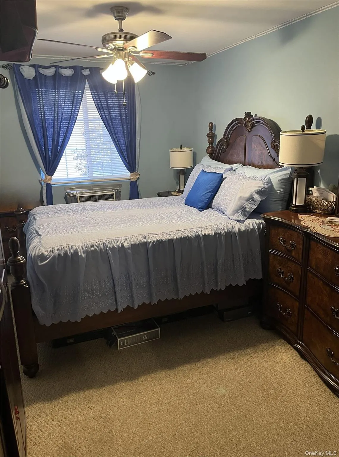 Bedroom with light carpet and a ceiling fan Bedroom with light carpet and a ceiling fan