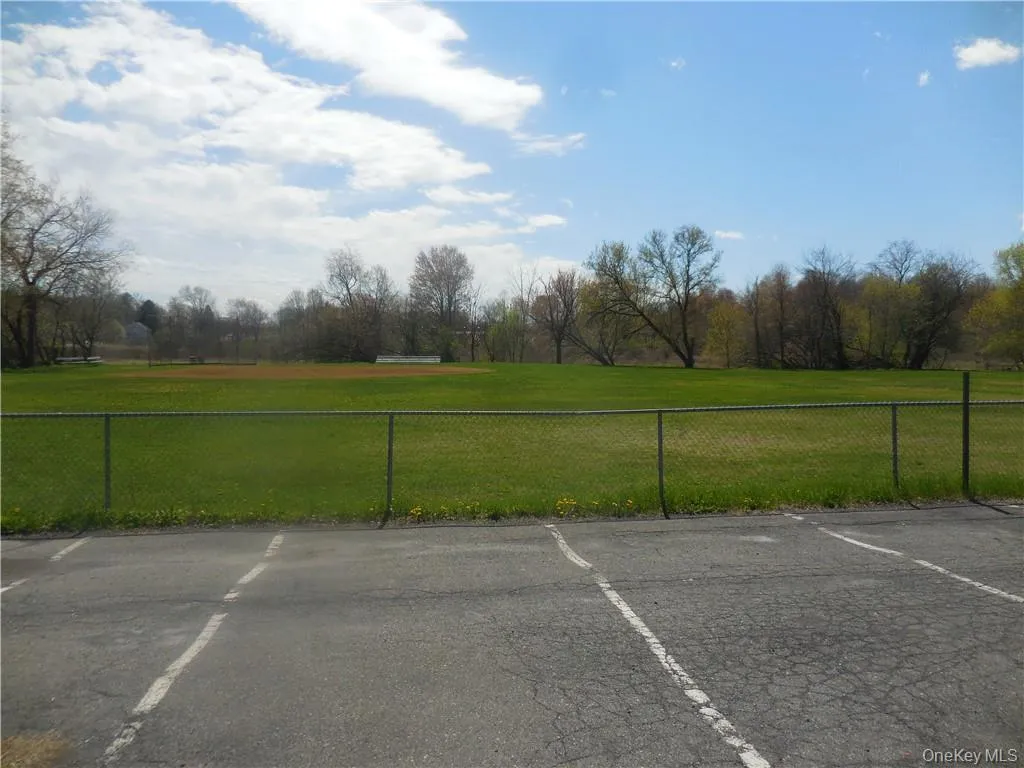 Across the street from the apartment the baseball field Across the street from the apartment the baseball field