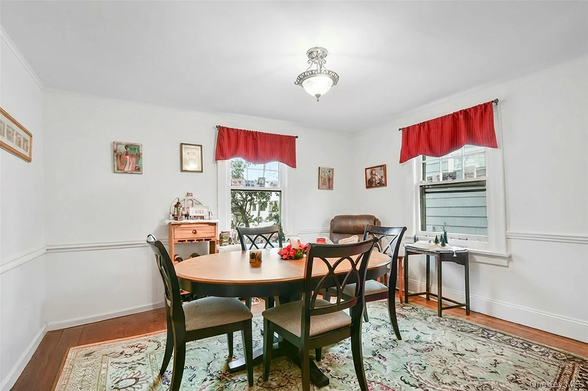 Dining room with wood finished floors and crown molding Dining room with wood finished floors and crown molding