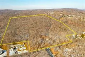 Aerial view of sparsely populated area with property parcel outlined and a desert landscape Aerial view of sparsely populated area with property parcel outlined and a desert landscape