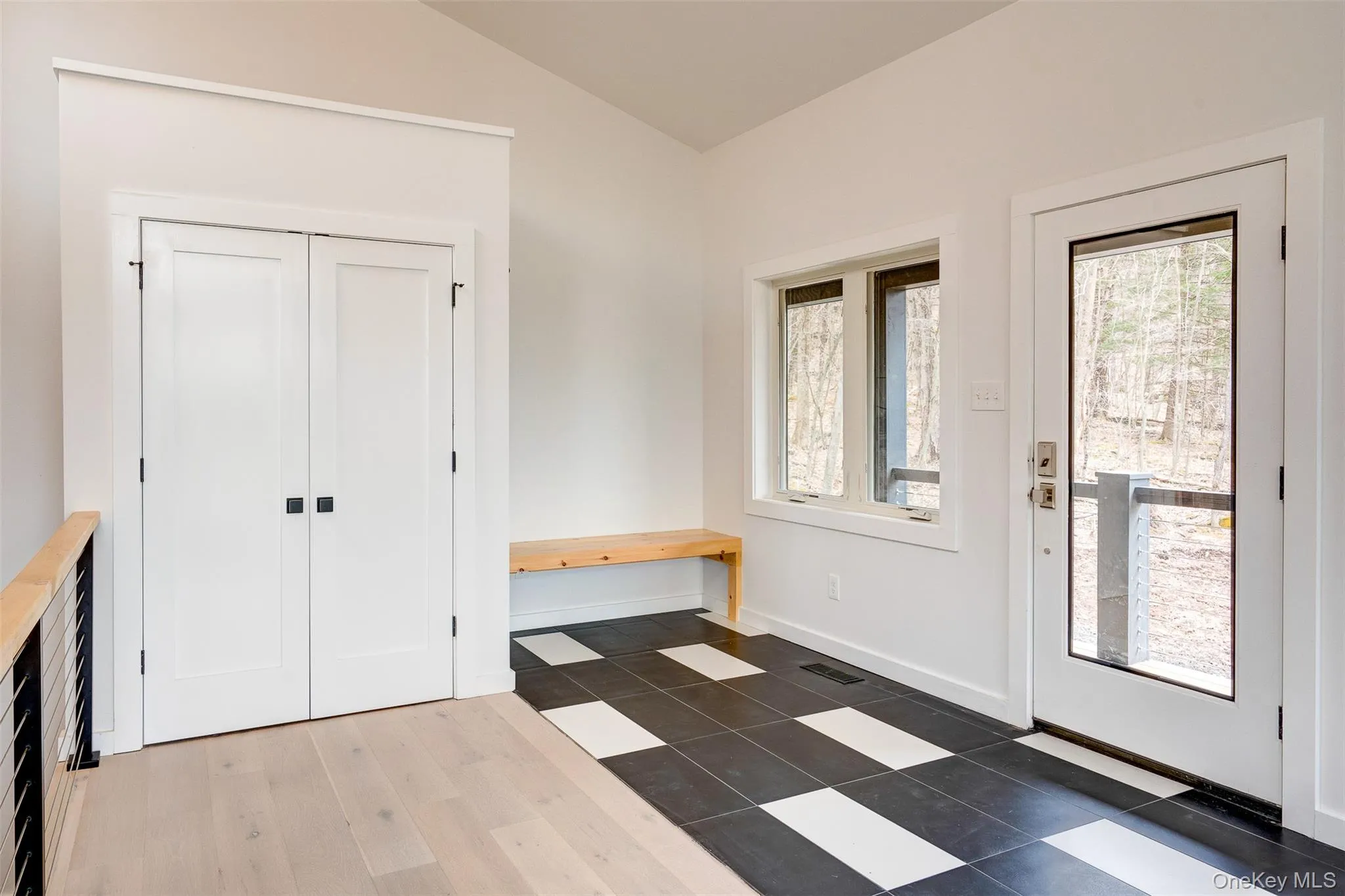 Foyer entrance featuring lofted ceiling and dark wood-style flooring Foyer entrance featuring lofted ceiling and dark wood-style flooring