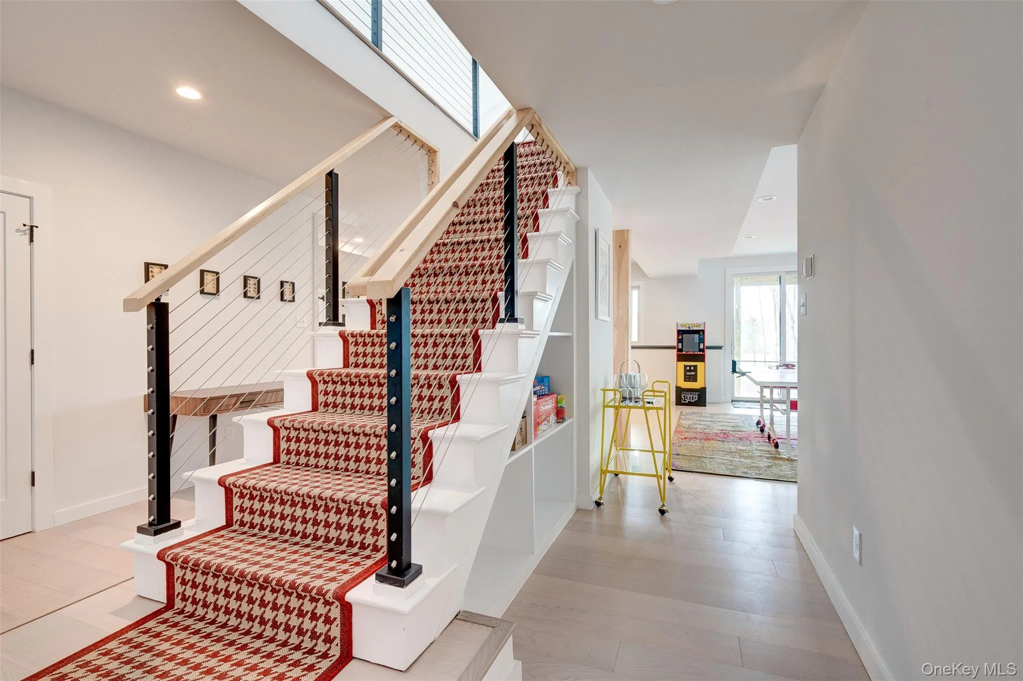 Staircase featuring recessed lighting and wood finished floors Staircase featuring recessed lighting and wood finished floors