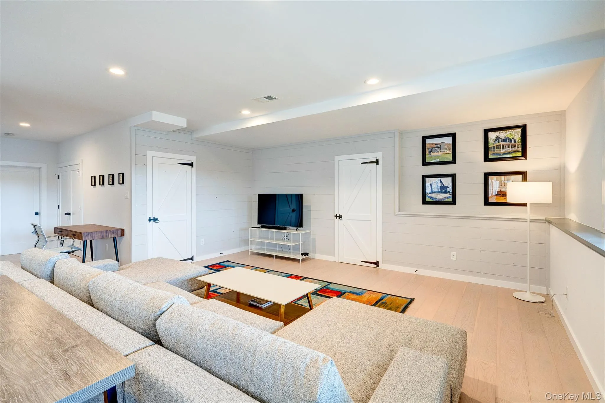 Living area featuring light wood-type flooring and recessed lighting Living area featuring light wood-type flooring and recessed lighting