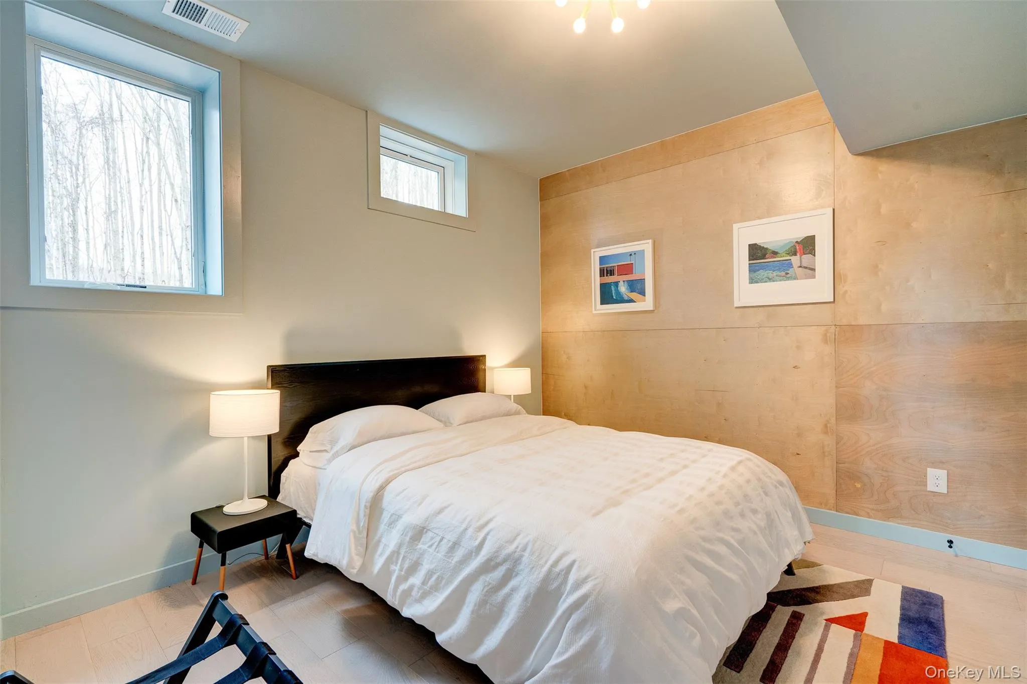 Bedroom featuring baseboards and wood finished floors Bedroom featuring baseboards and wood finished floors