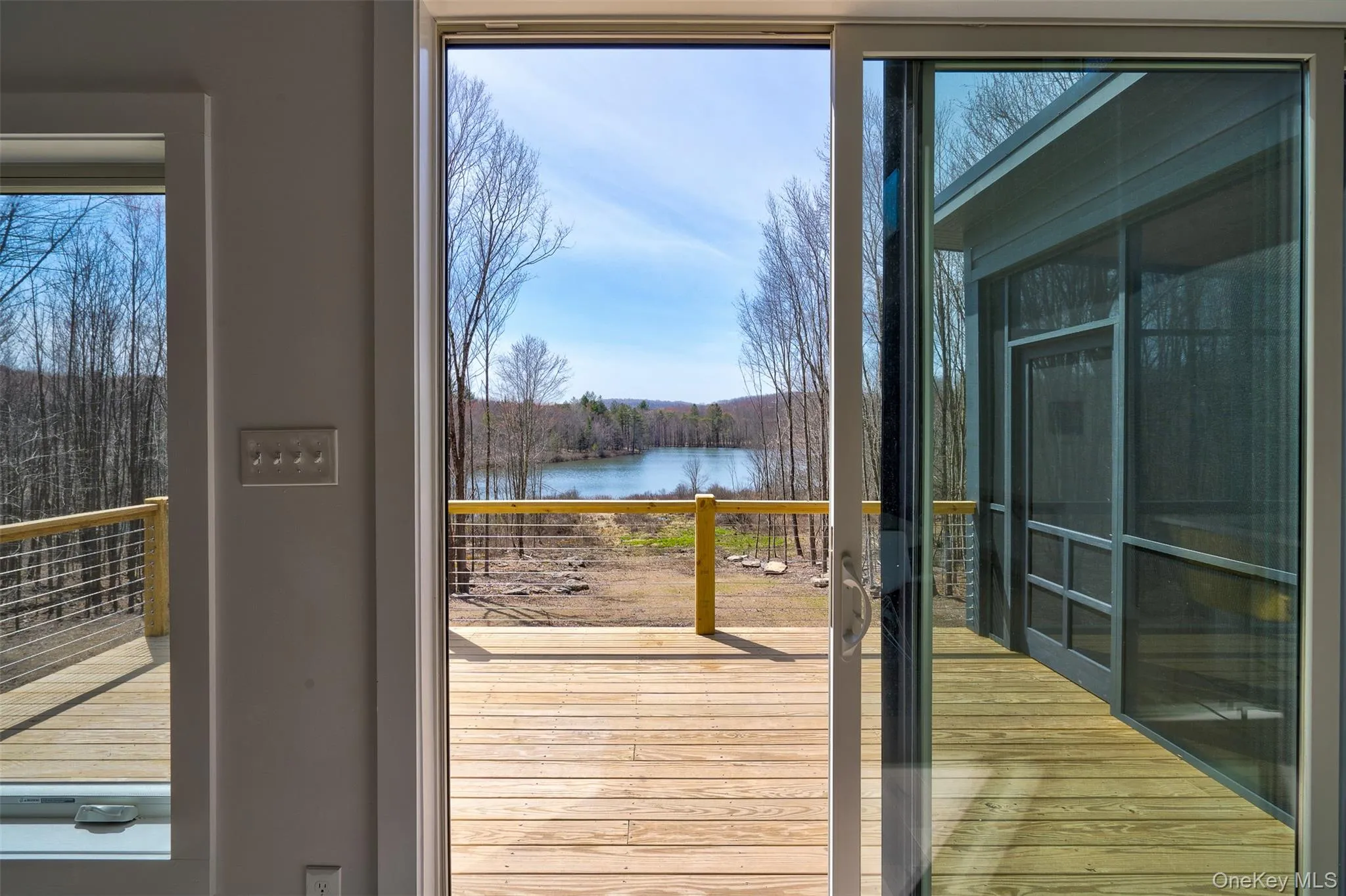 Doorway with a water view, plenty of natural light, and hardwood / wood-style floors Doorway with a water view, plenty of natural light, and hardwood / wood-style floors