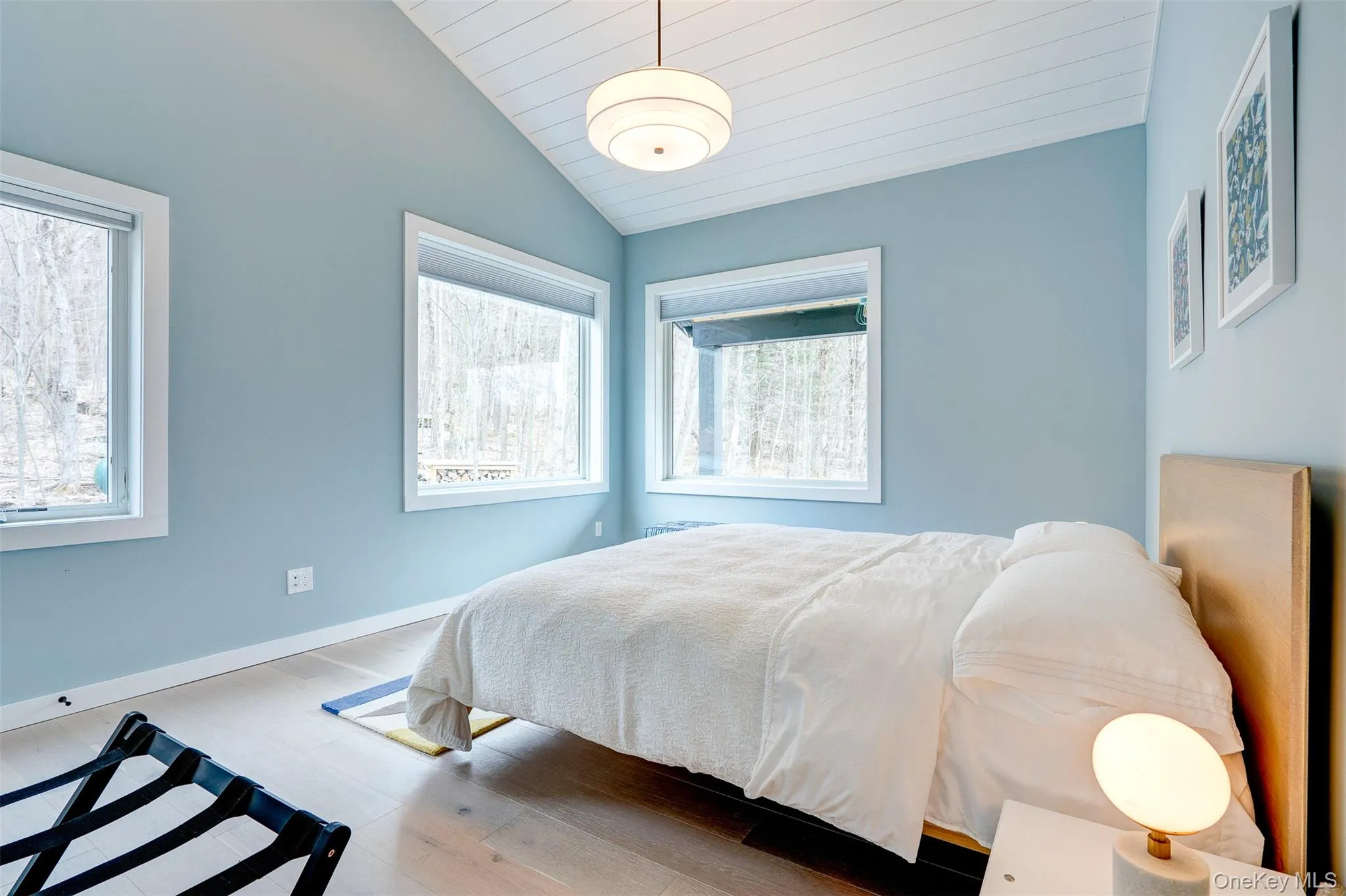 Bedroom featuring lofted ceiling and hardwood / wood-style flooring Bedroom featuring lofted ceiling and hardwood / wood-style flooring