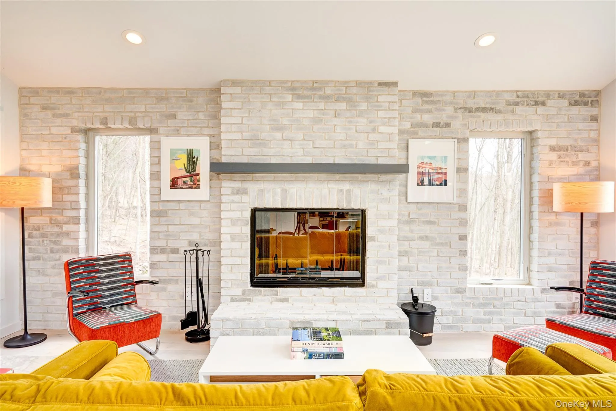 Living room with brick wall, a brick fireplace, and recessed lighting Living room with brick wall, a brick fireplace, and recessed lighting