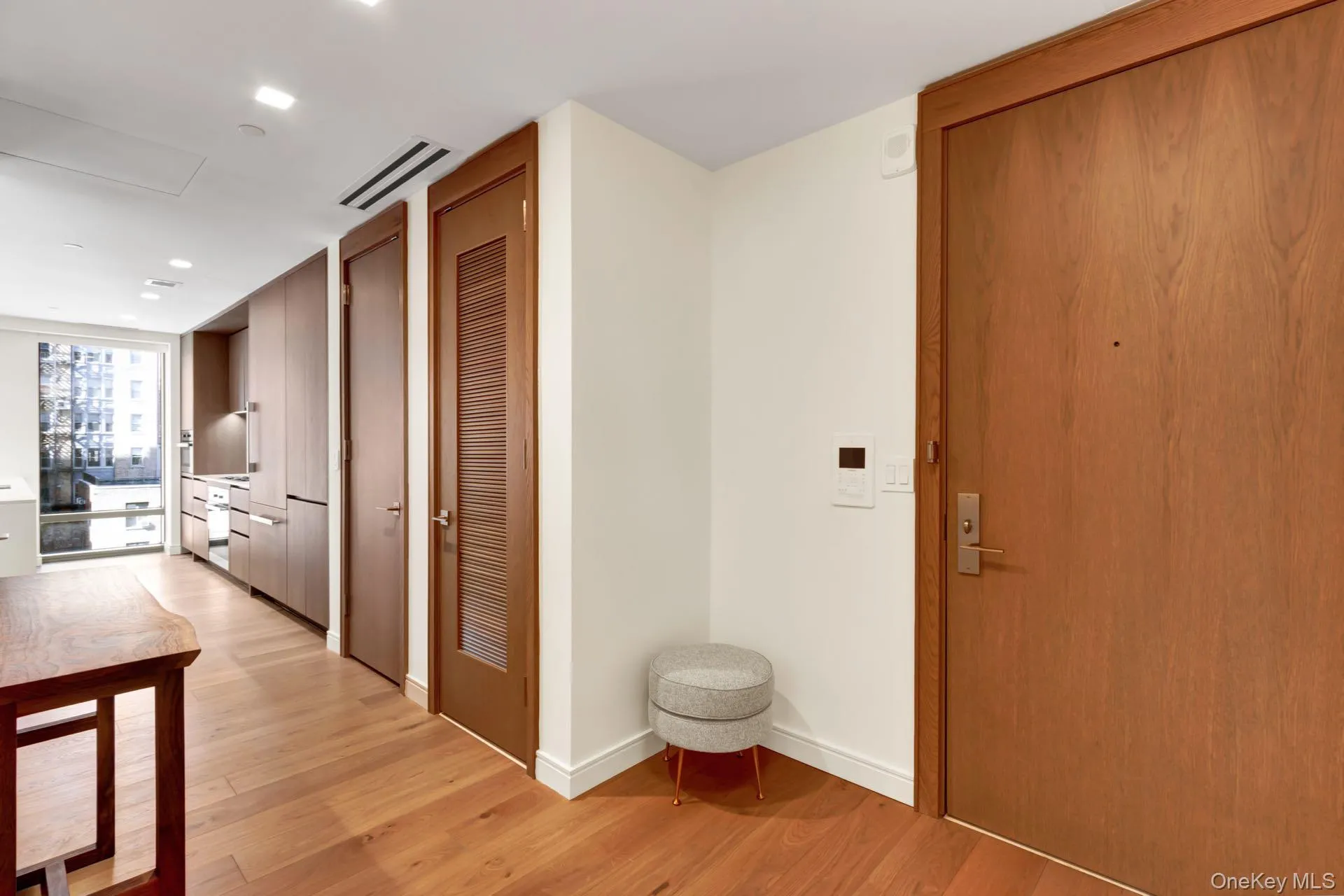 Hall with light wood finished floors and recessed lighting Hall with light wood finished floors and recessed lighting
