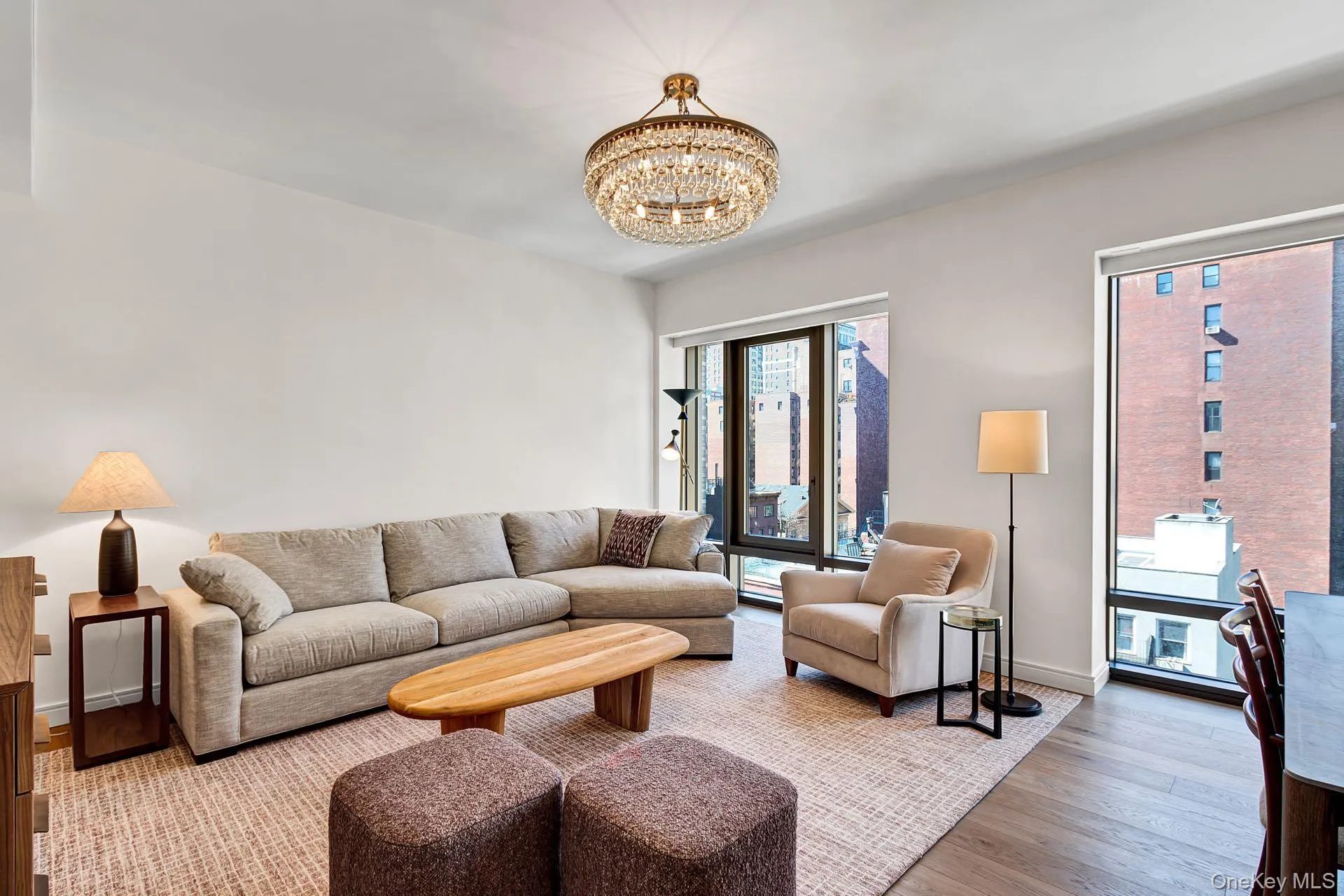 Living room featuring wood finished floors and a chandelier Living room featuring wood finished floors and a chandelier